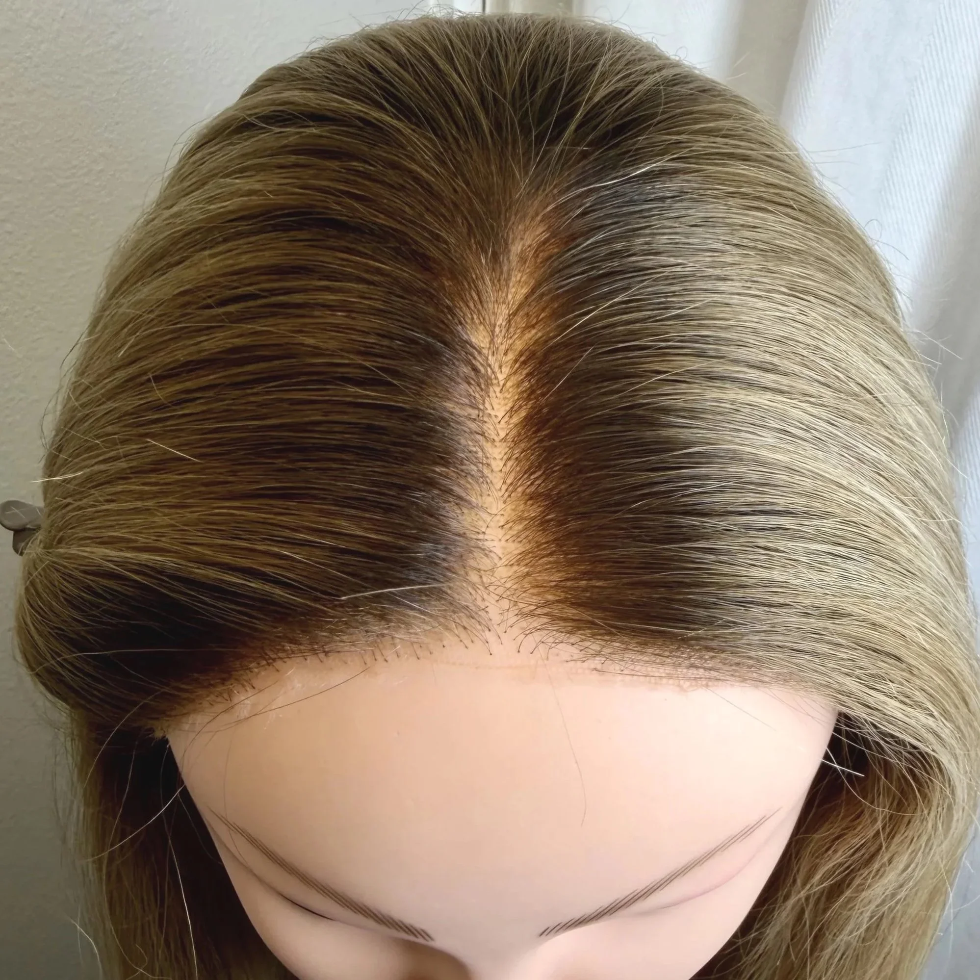 Top View of wig on mannequin with the parting filled in.