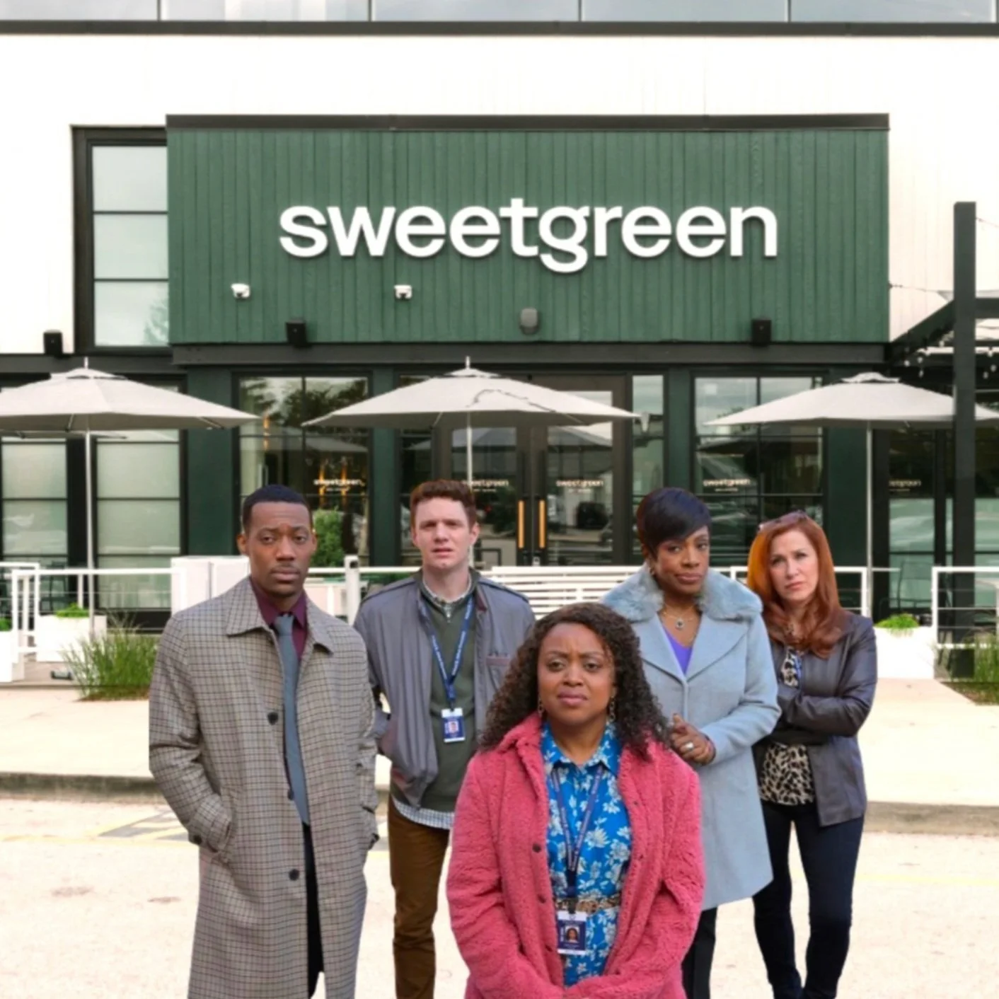 Group of five people standing in front of a building with the sign 'sweetgreen' on it.