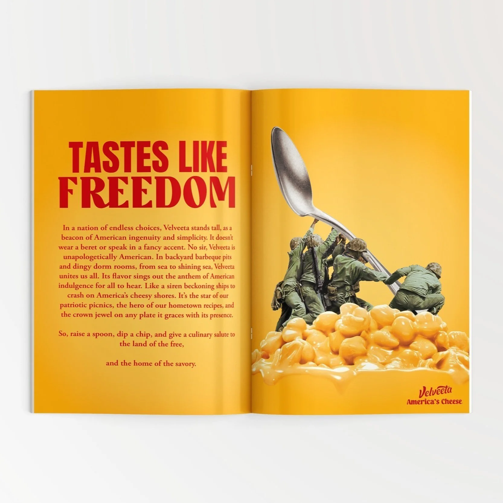 An open magazine spread featuring an advertisement for Velveeta cheese. The left page has large red text reading "TASTES LIKE FREEDOM" with smaller text praising American ingenuity and love of cheese. The right page shows a mashed potato and cheese dish with a sculpture of soldiers raising a giant spoon, set against a yellow background. The Velveeta logo appears at the bottom right corner.