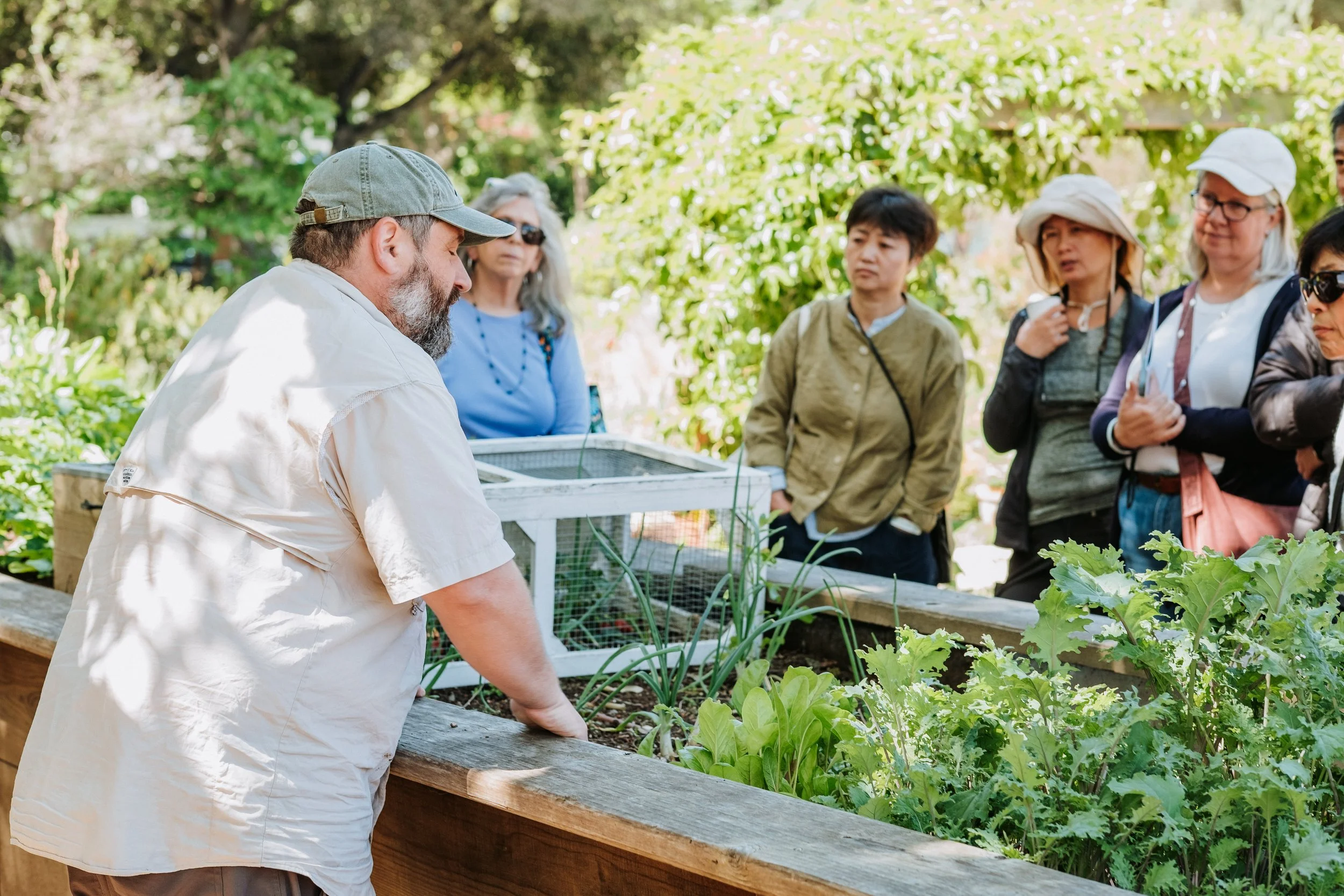 Gardening Director, Corey, teaching about growing food in raised beds