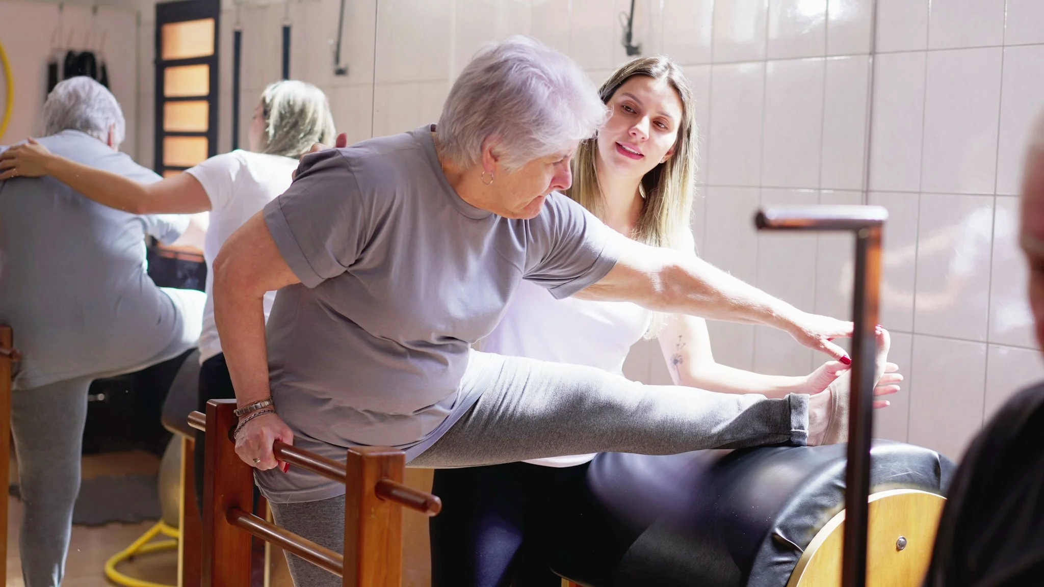 Senior on Pilates ladder barrel