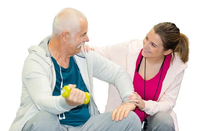 Instructor reassuring an older man with an exercise