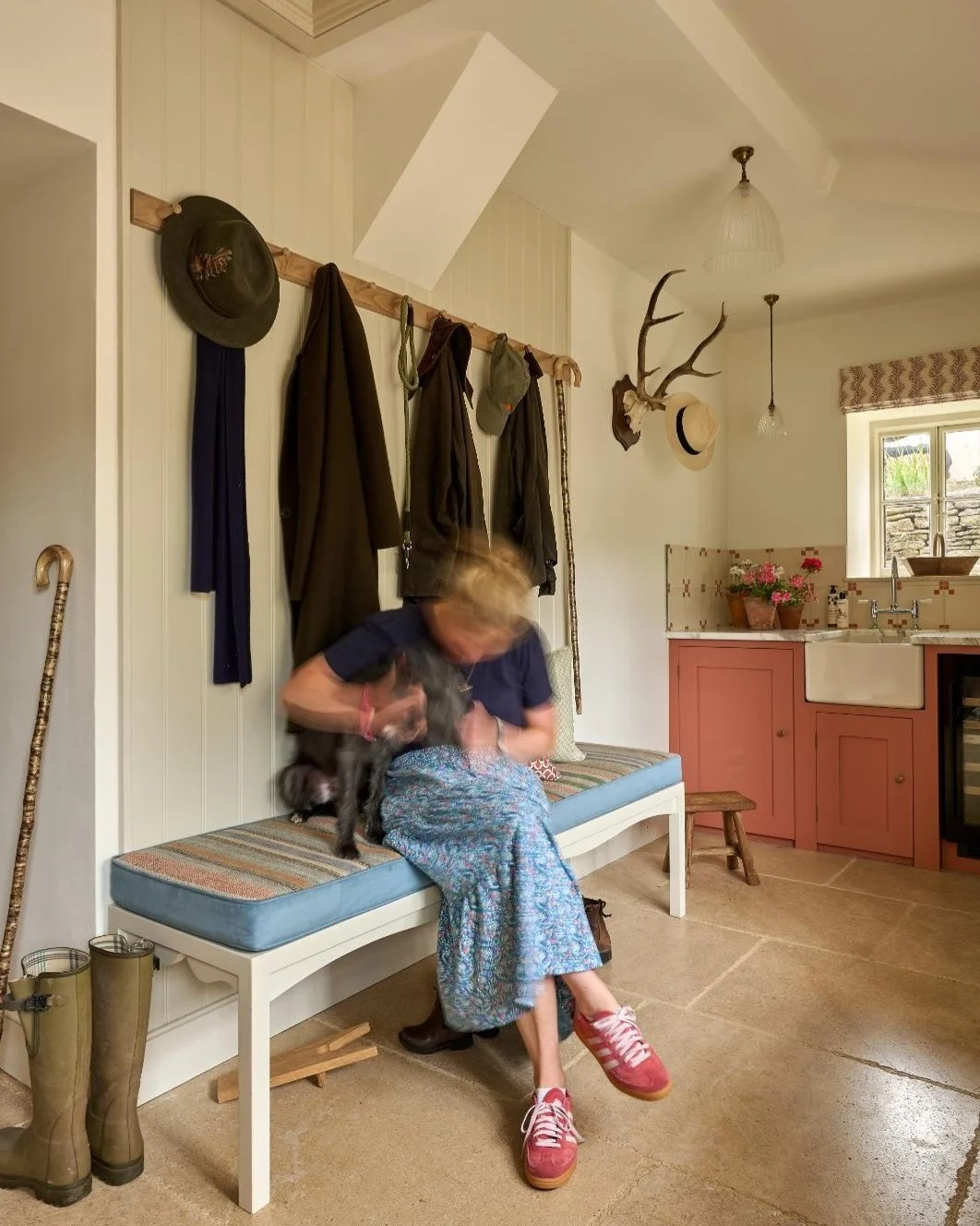 Busted cuddling adorable Reggie whilst styling the boot room! 

This is such a key room for a family house, the most hardworking room which needs to be functional and look nice. Simple details like the bench cushion, antlers and pretty lighting all h