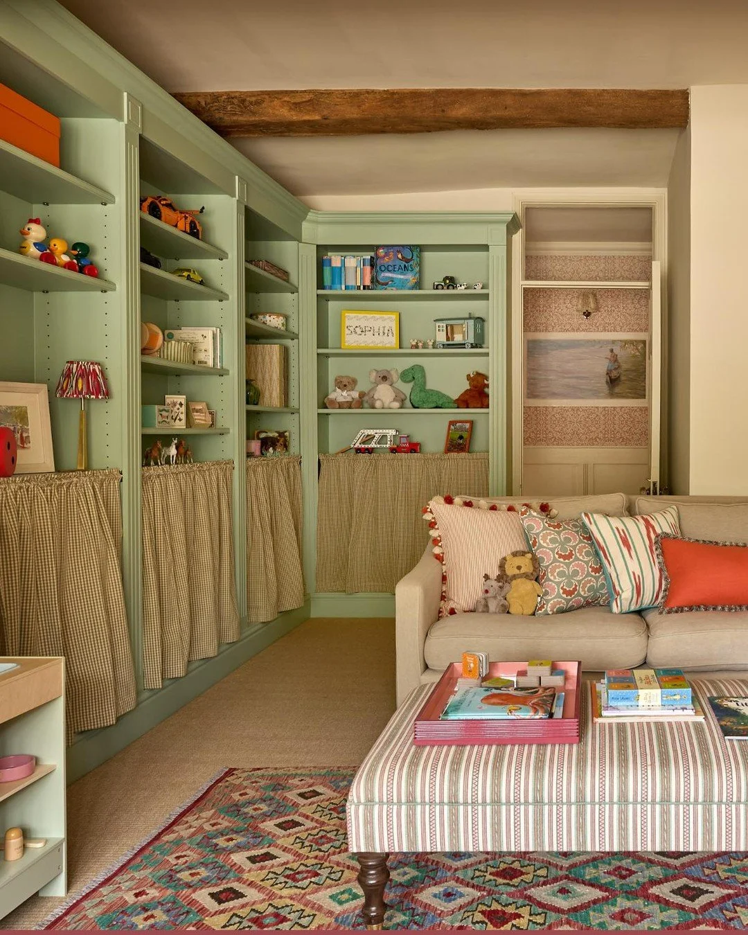 A family playroom designed with little people in mind 💚

We added curtains to the lower shelves of the bookcase to hide the chaos, while keeping toys easily accessible for the children.

Warm and cosy, the space is layered with plenty of cushions an