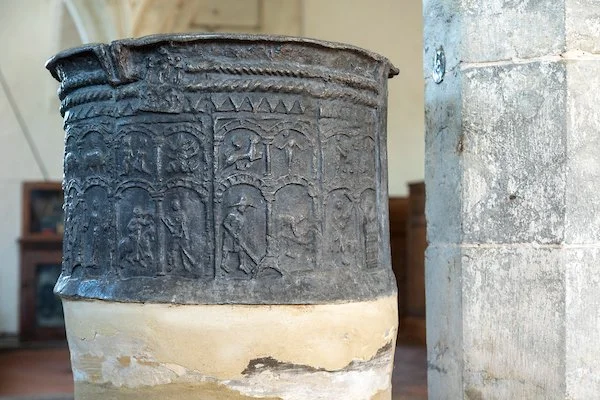The circular font shows the signs of the Zodiac above the Labours of the Months. It pre-dates the church, to around 1175.