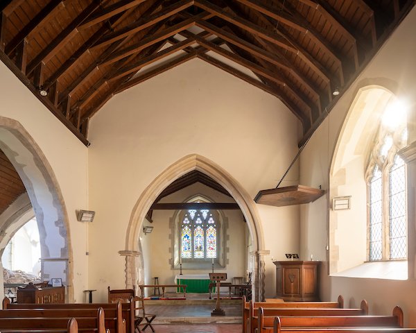 The chancel arch has Norman roll and chevron work in its lower half, dating to the 12th century.