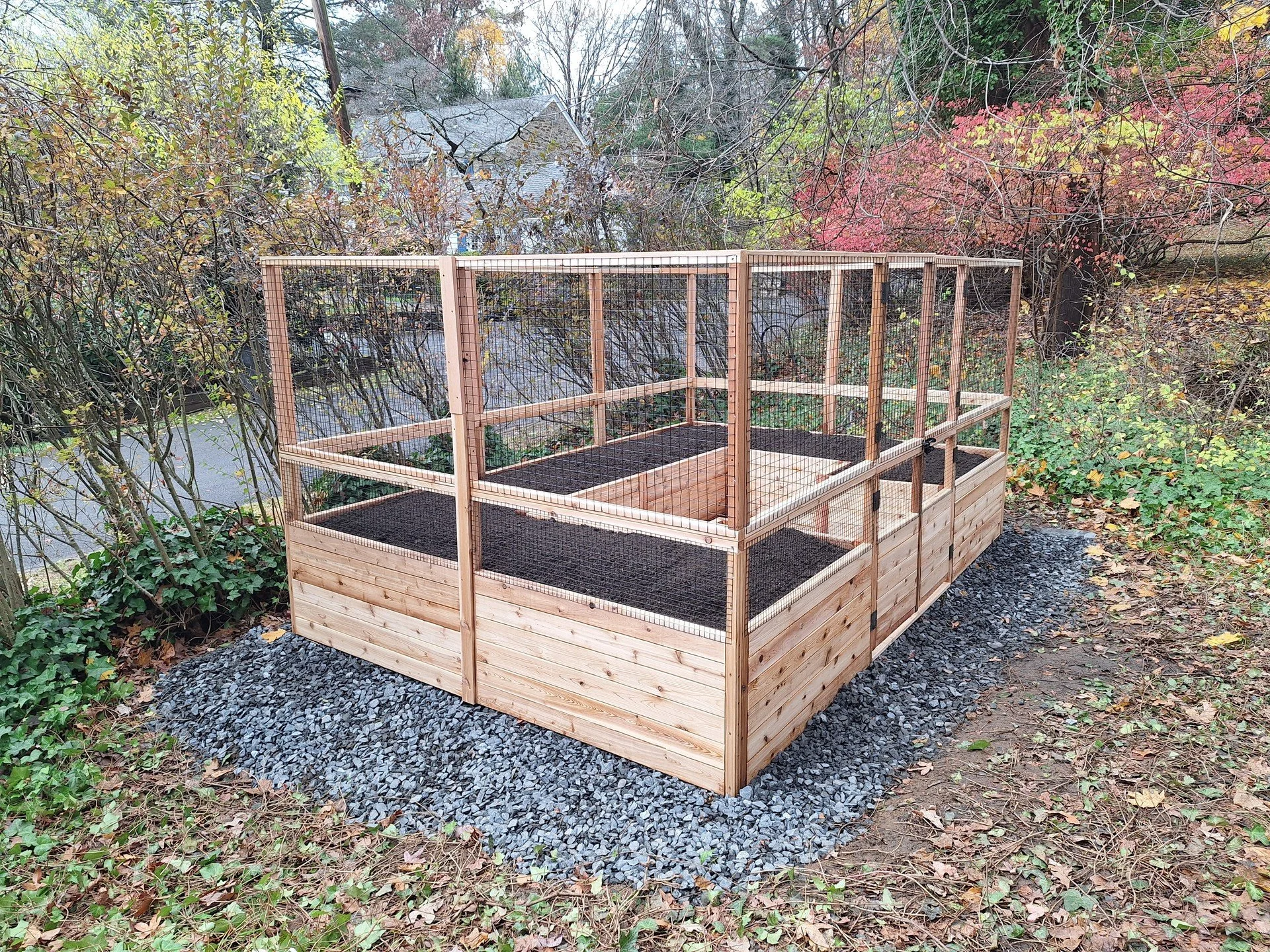 We finished this new vegetable garden this week! 

The tall beautiful trees lining the front yard along the street made locating a sunny spot for vegetable gardening a challenge. We ended up going with an English-ivy-covered side yard - not an obviou