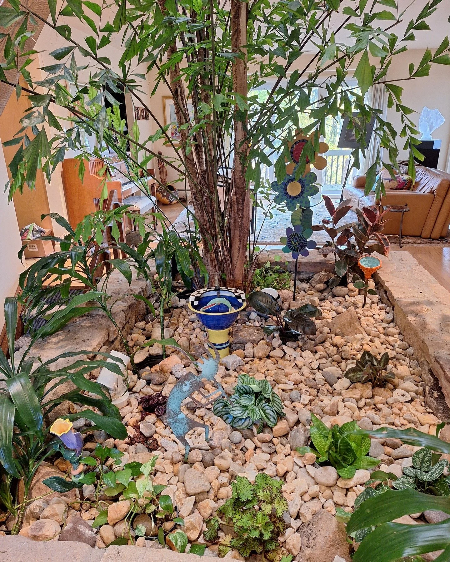 This was a fun &amp; unusual (for us) design project this fall. The client has an indoor garden in their home, with a 20+ ft. Fishtail Palm growing in the ground! So there's a direct soil connection inside the building envelope. The rest of the plant