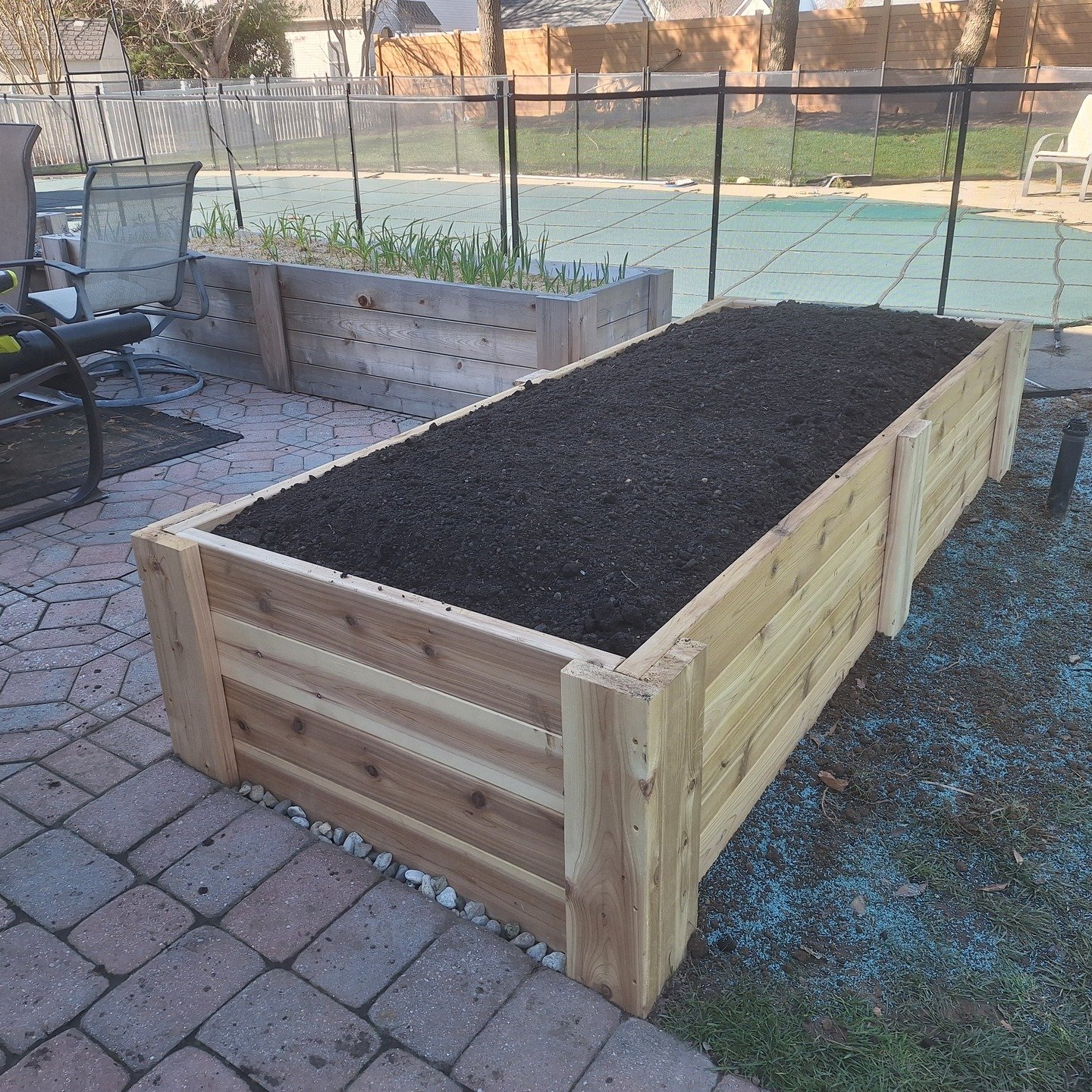 This one's from last week. 

We took apart an ornamental bed with two shrubs and rocks which the client was totally fine parting with. In its place, we put a beautiful cedar raised bed and filled it with a garden soil blend. We graded around the bed 