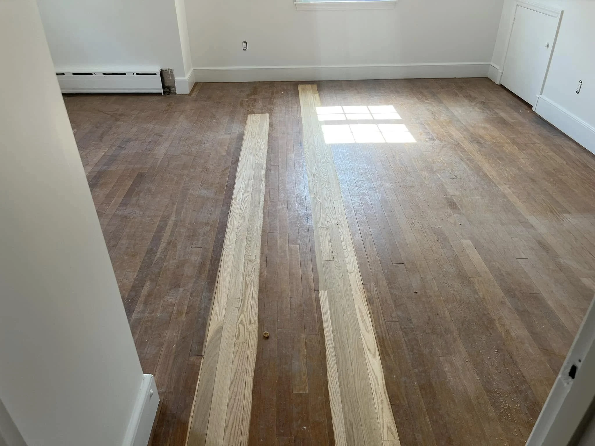 Replaced water-damaged hardwood in the kitchen, installed and weaved in new red oak, then sanded and finished with three coats of oil-based polyurethane in a high-gloss sheen.