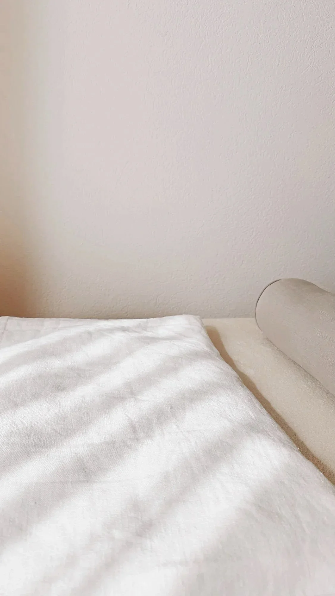 Minimalist cushion in cream colors with gentle natural light