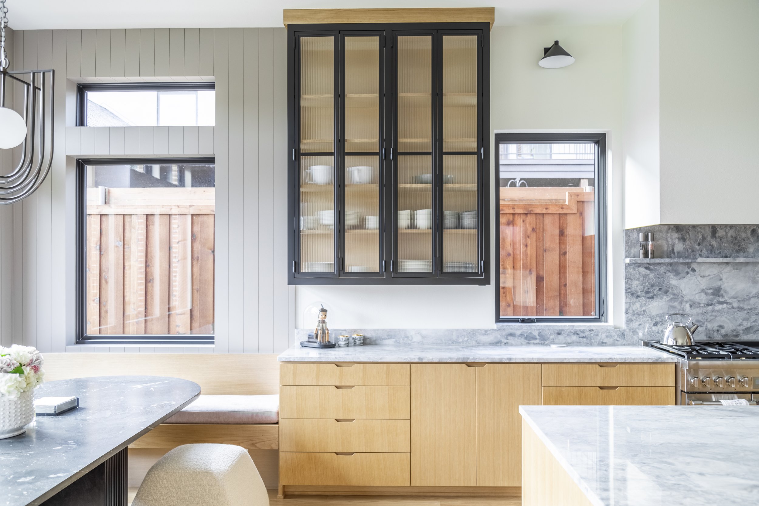 Rift Cut White Oak; Single Piece Door and Drawer Style with Finger Pulls; Full Overlay Cabinet Design; Metal Upper Glass Doors By Others