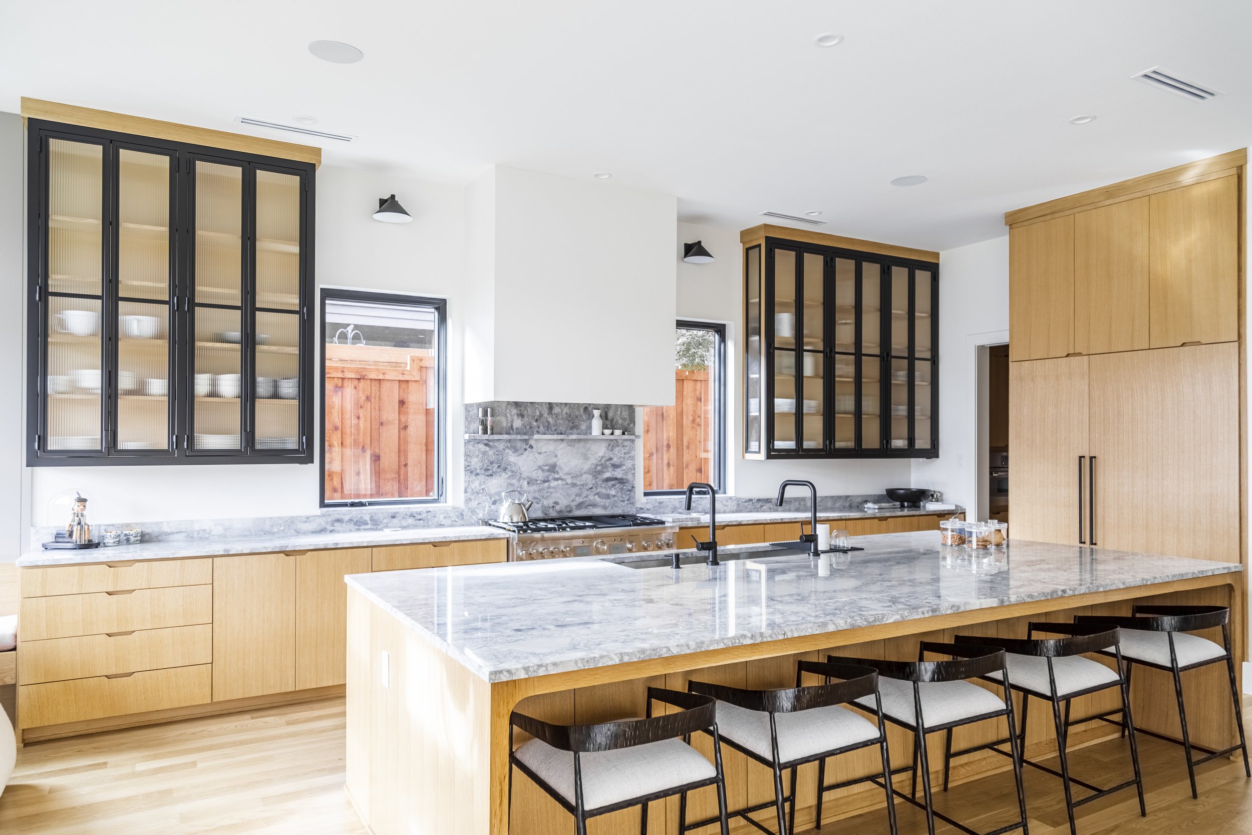 Rift Cut White Oak; Single Piece Door and Drawer Style with Finger Pulls; Full Overlay Cabinet Design; Metal Upper Glass Doors By Others