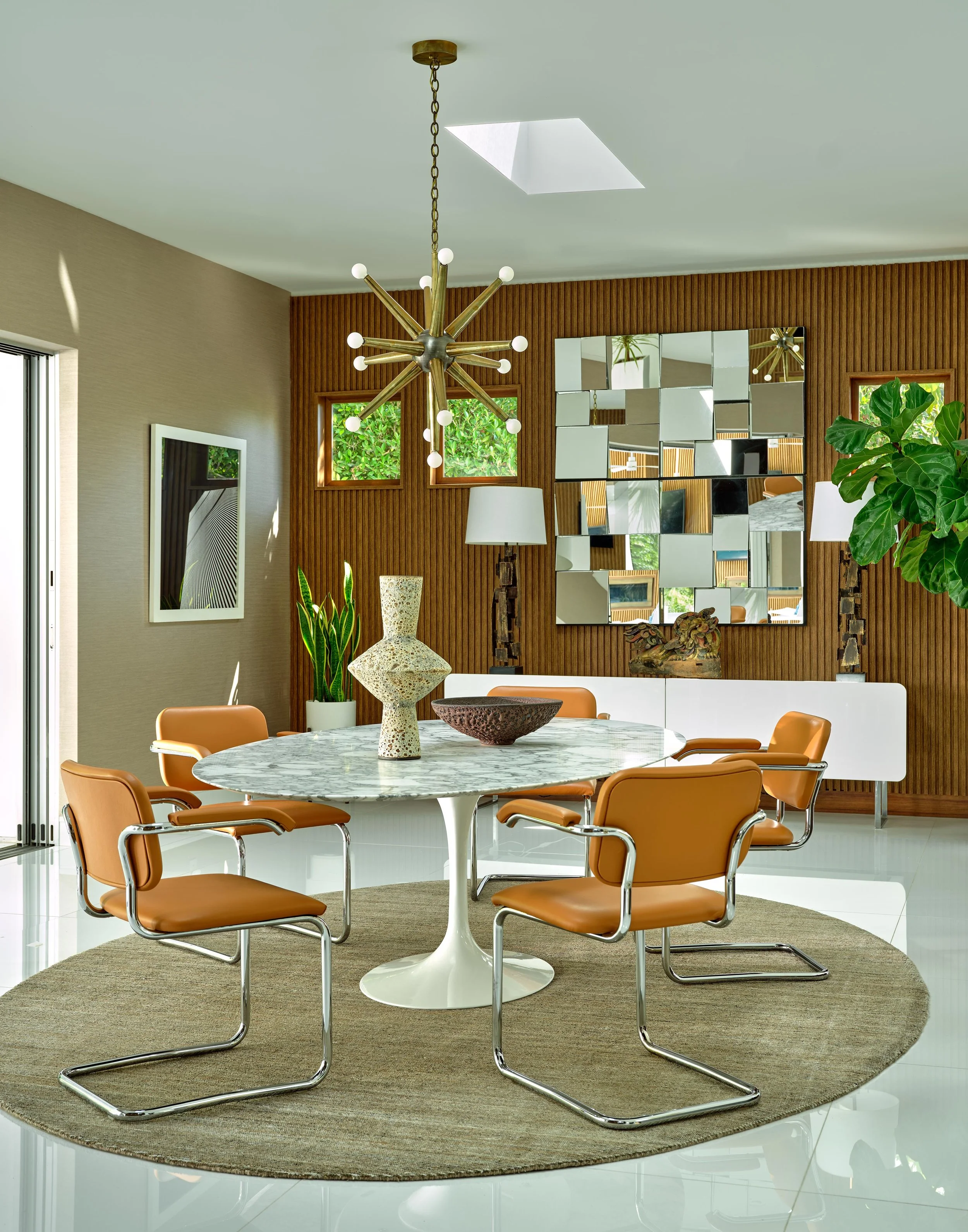 Custom dining area of Trousdale Estates area, Beverly Hills luxury home featuring modern table and seating, starburst chandelier and mid-century accents, full-service interior design by Stephen Pappas Interiors, Los Angeles