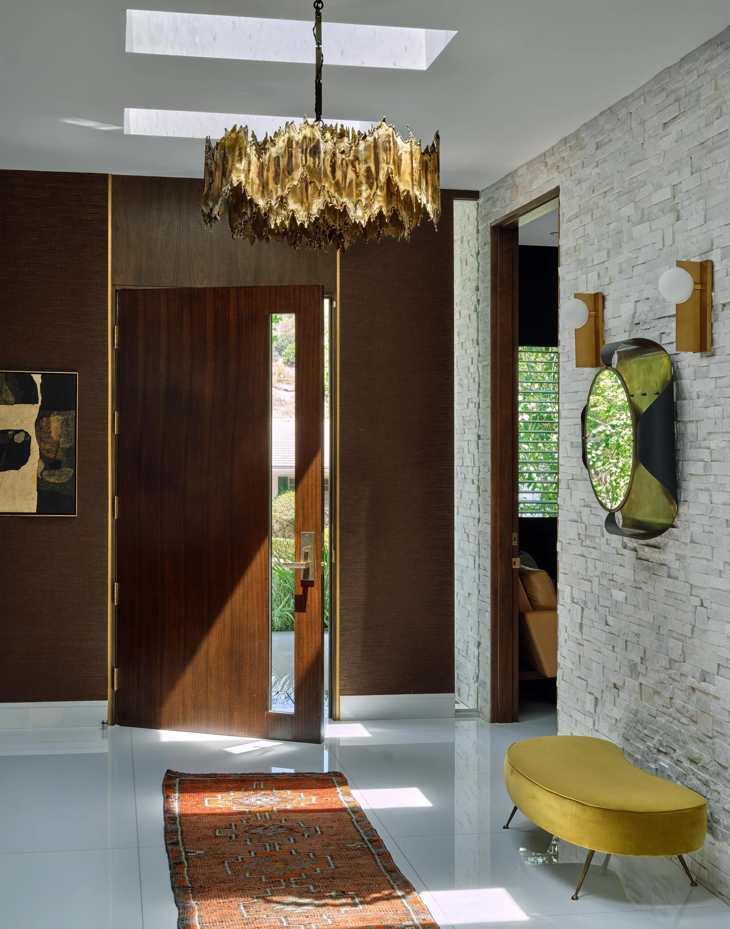 Entryway detail of Trousdale Estates area, Beverly Hills luxury home featuring modern architectural elements and a chic chandelier, full-service interior design by Stephen Pappas Interiors, Los Angeles