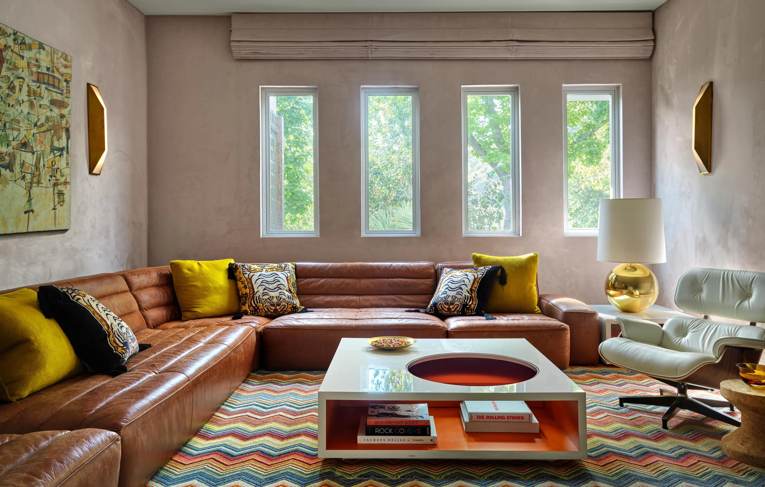 Media room of Trousdale Estates area, Beverly Hills luxury home featuring low modern leather sectional, geometric cut out coffee table and chic accents, full-service interior design by Stephen Pappas Interiors, Los Angeles