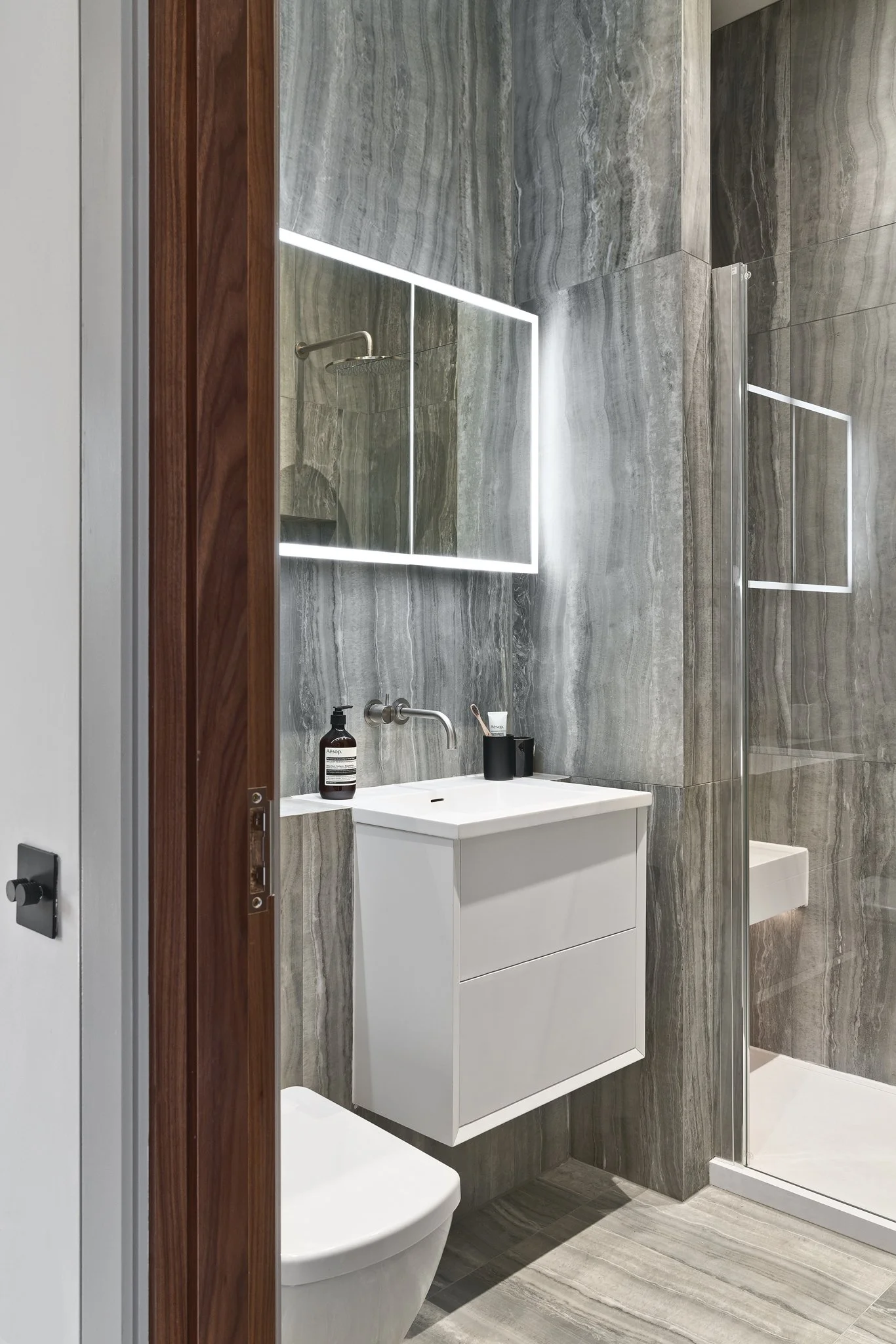Modern London townhouse bathroom in grey marble with free standing bath