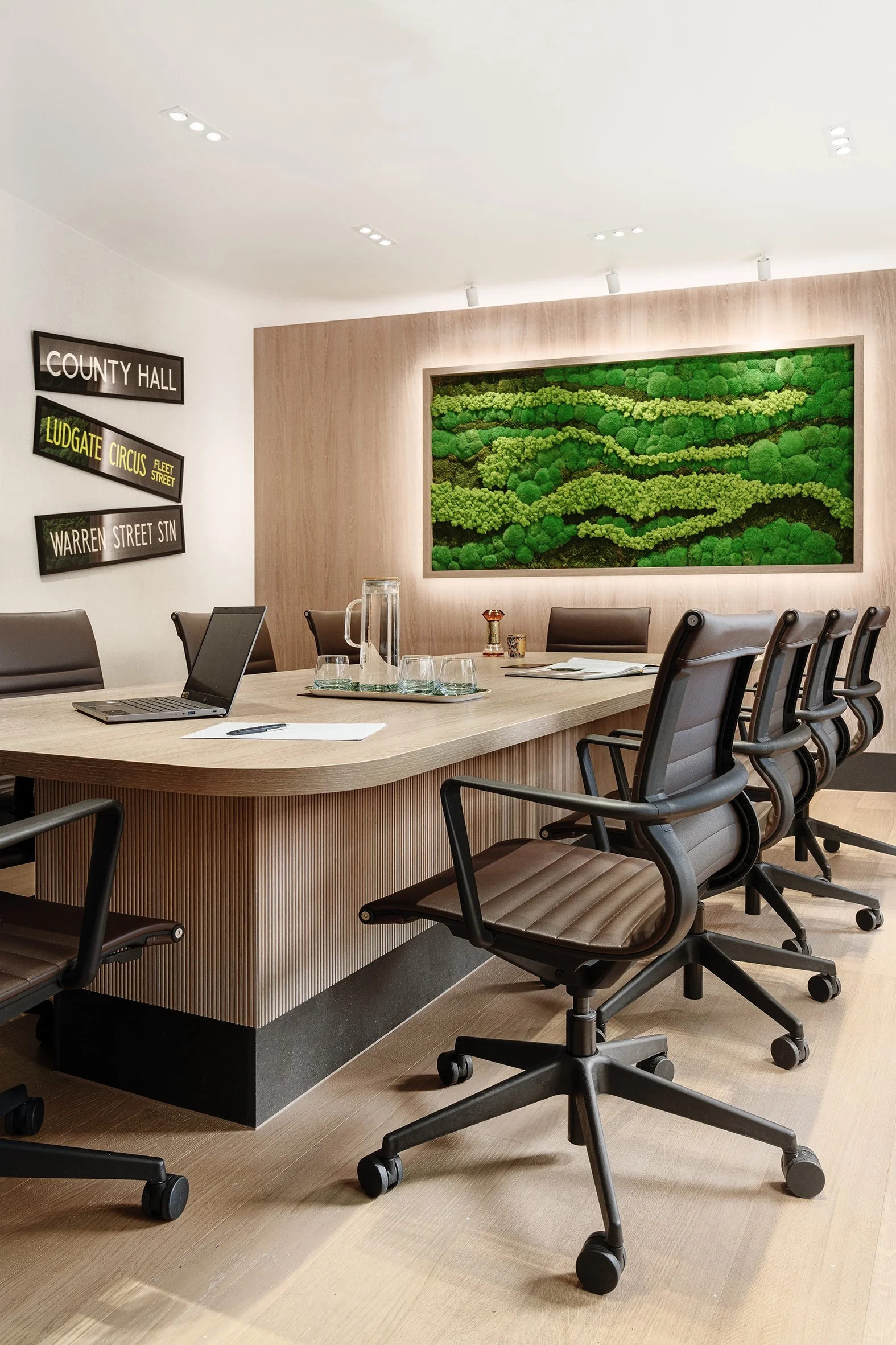 Contemporary meeting room with wood panelling and moss art in Oxford Street, London