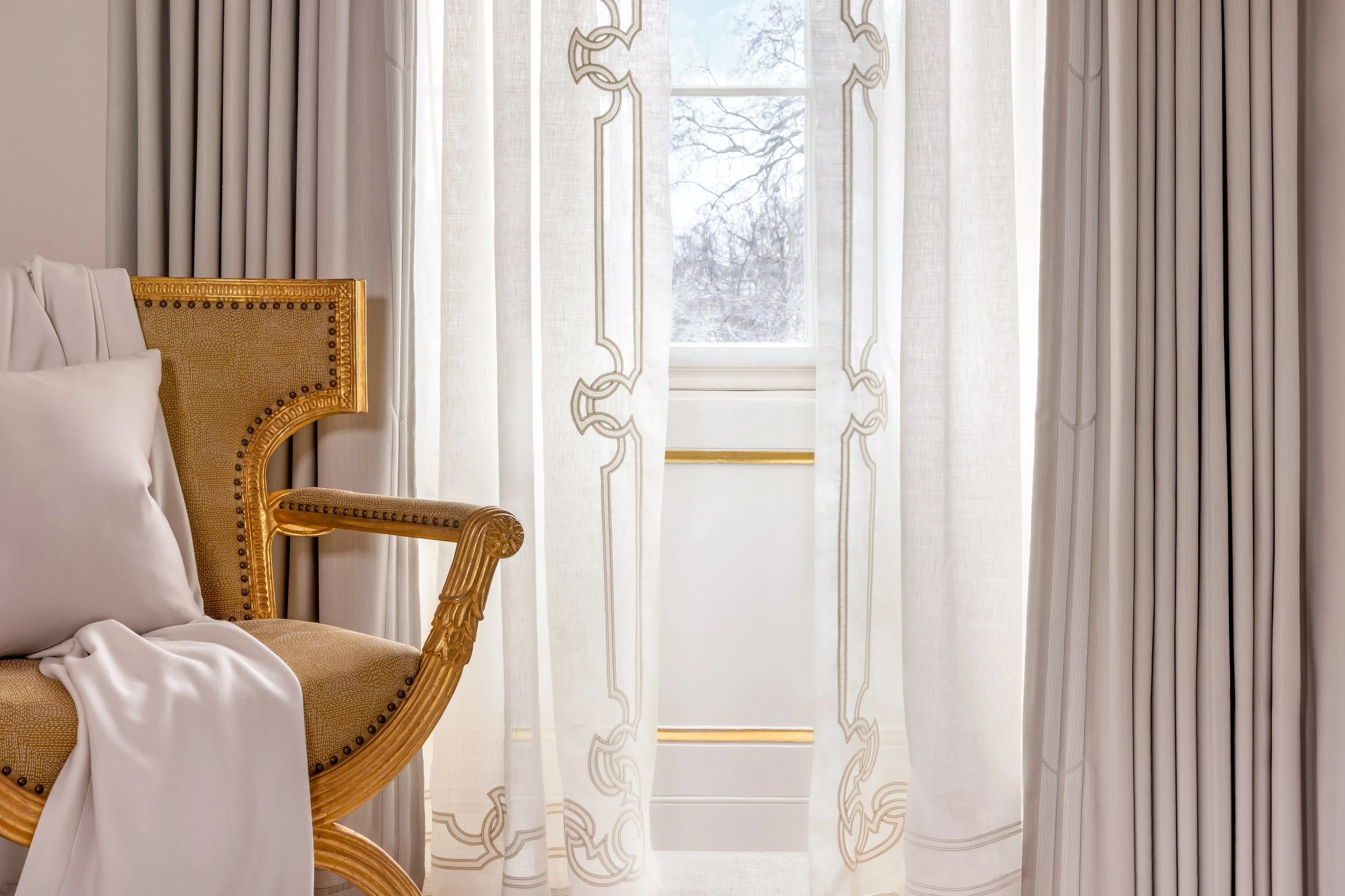 Embroidered Holland & Sherry sheer curtains and matching bespoke embroidered curtains in a luxury Belgravia primary bedroom
