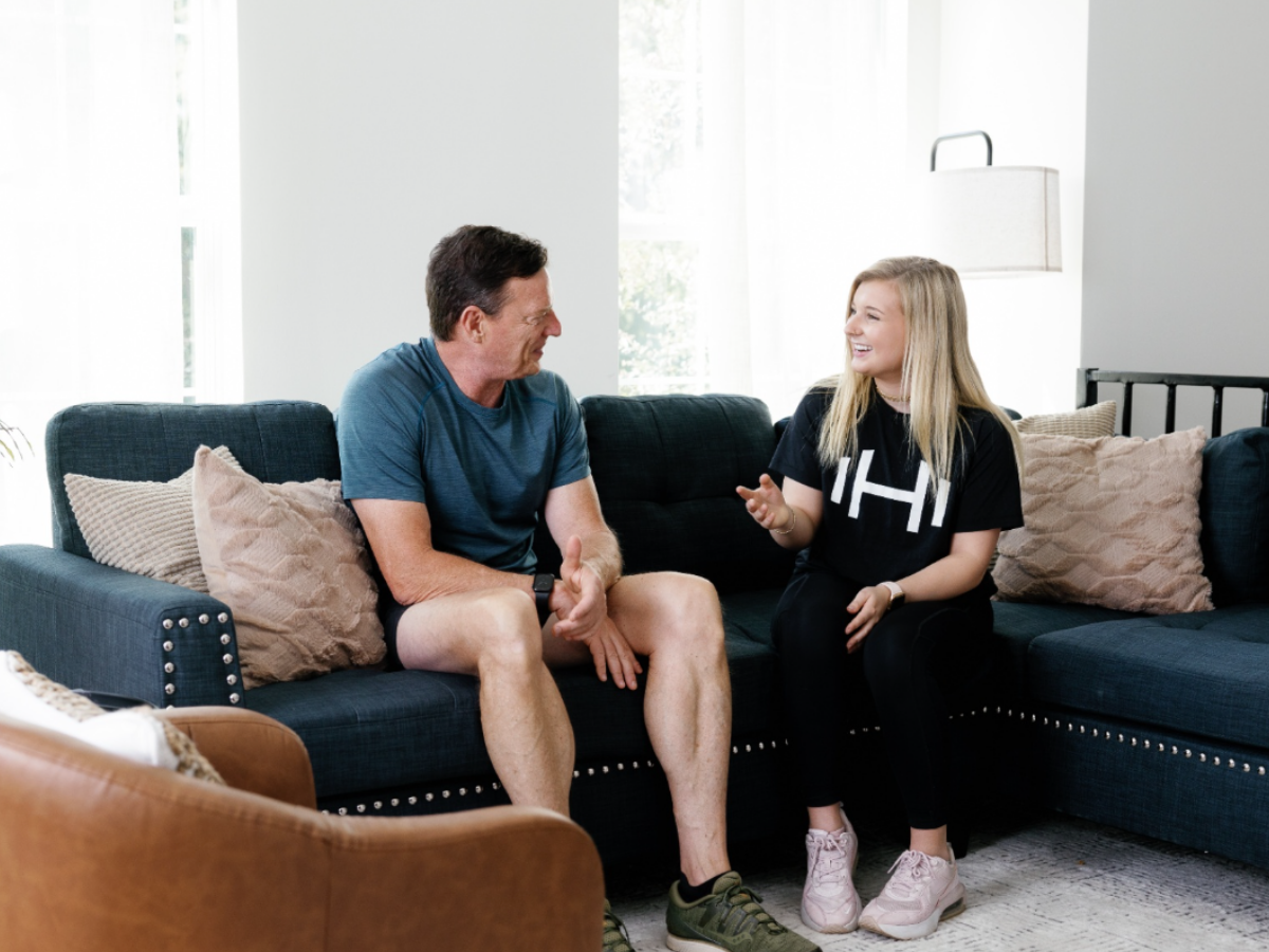 HOMEFIT trainer meeting with a client in a living room for personalized in-home fitness coaching and accountability support.