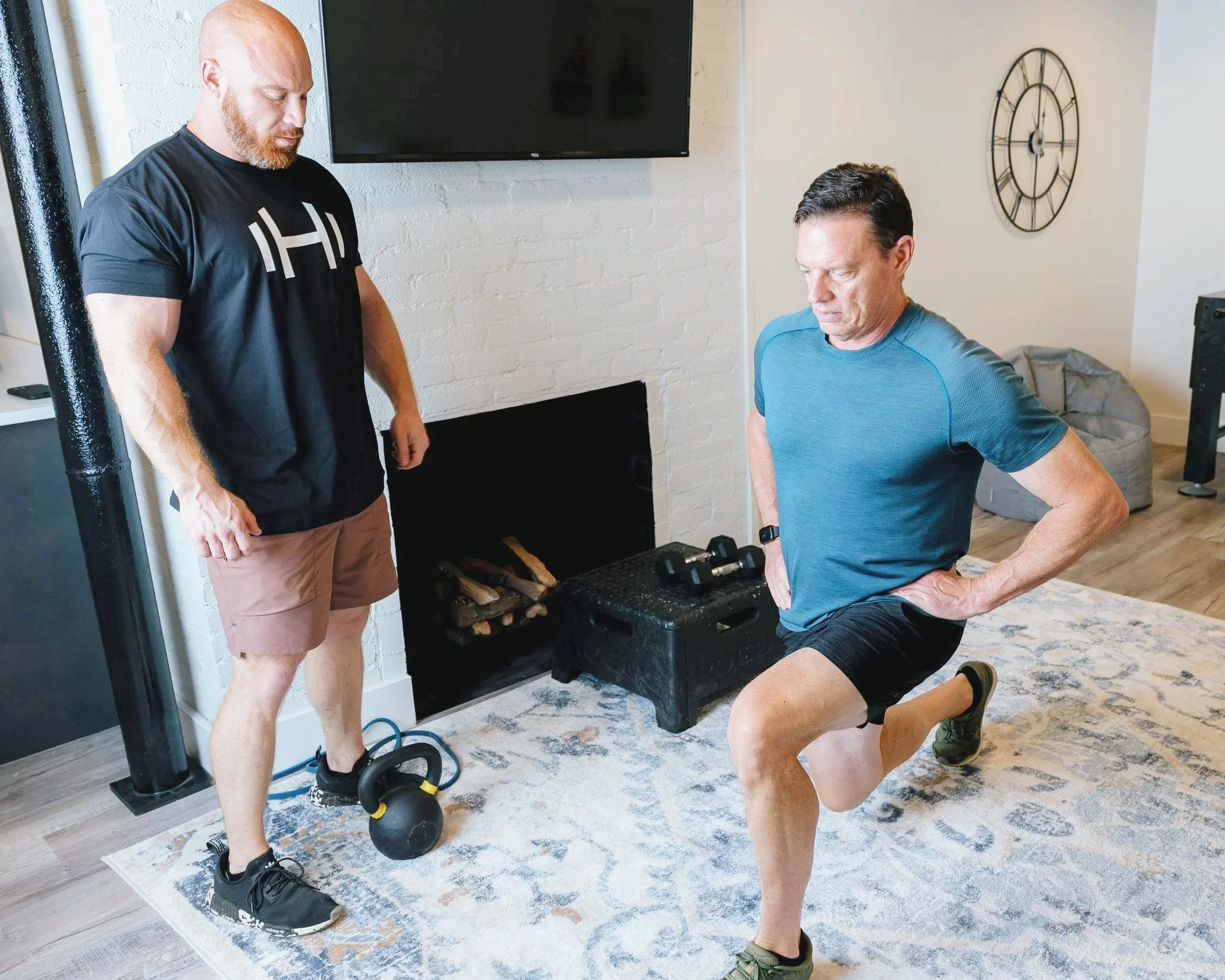HOMEFIT personal trainer client doing lunges in a living room