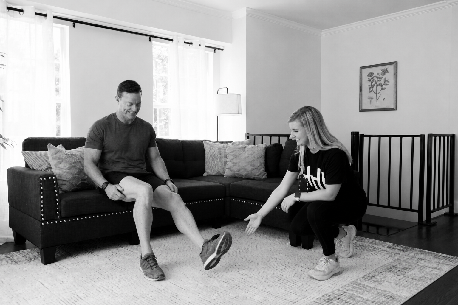 HOMEFIT in-home personal trainer coaching a client through a lower-body exercise at home, combining personalized strength training, mobility, and functional fitness.