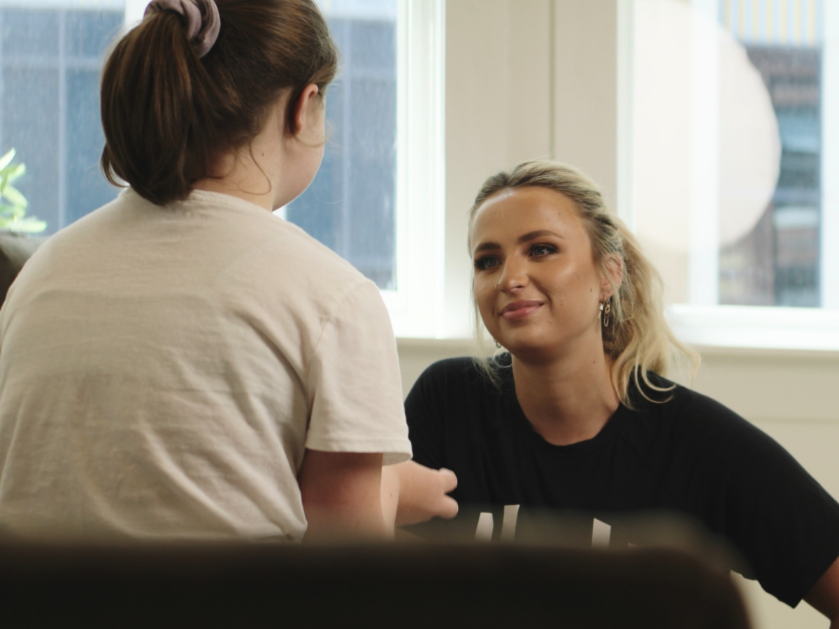 HOMEFIT coach interacting with a child indoors, highlighting family-focused wellness coaching, healthy lifestyle support, and personalized in-home fitness services.