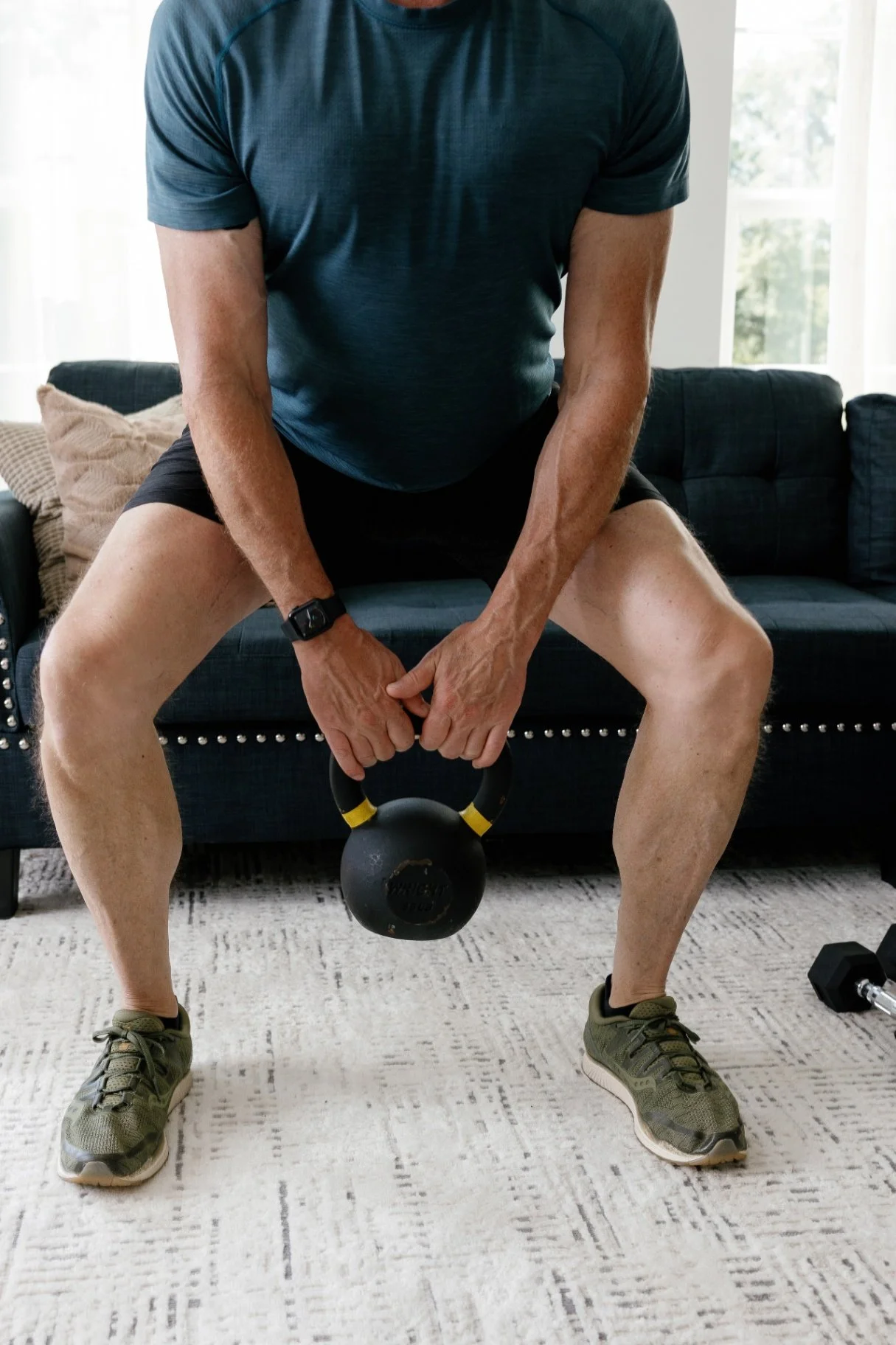 In-home kettlebell workout in a living room setup designed for busy professionals building a home gym