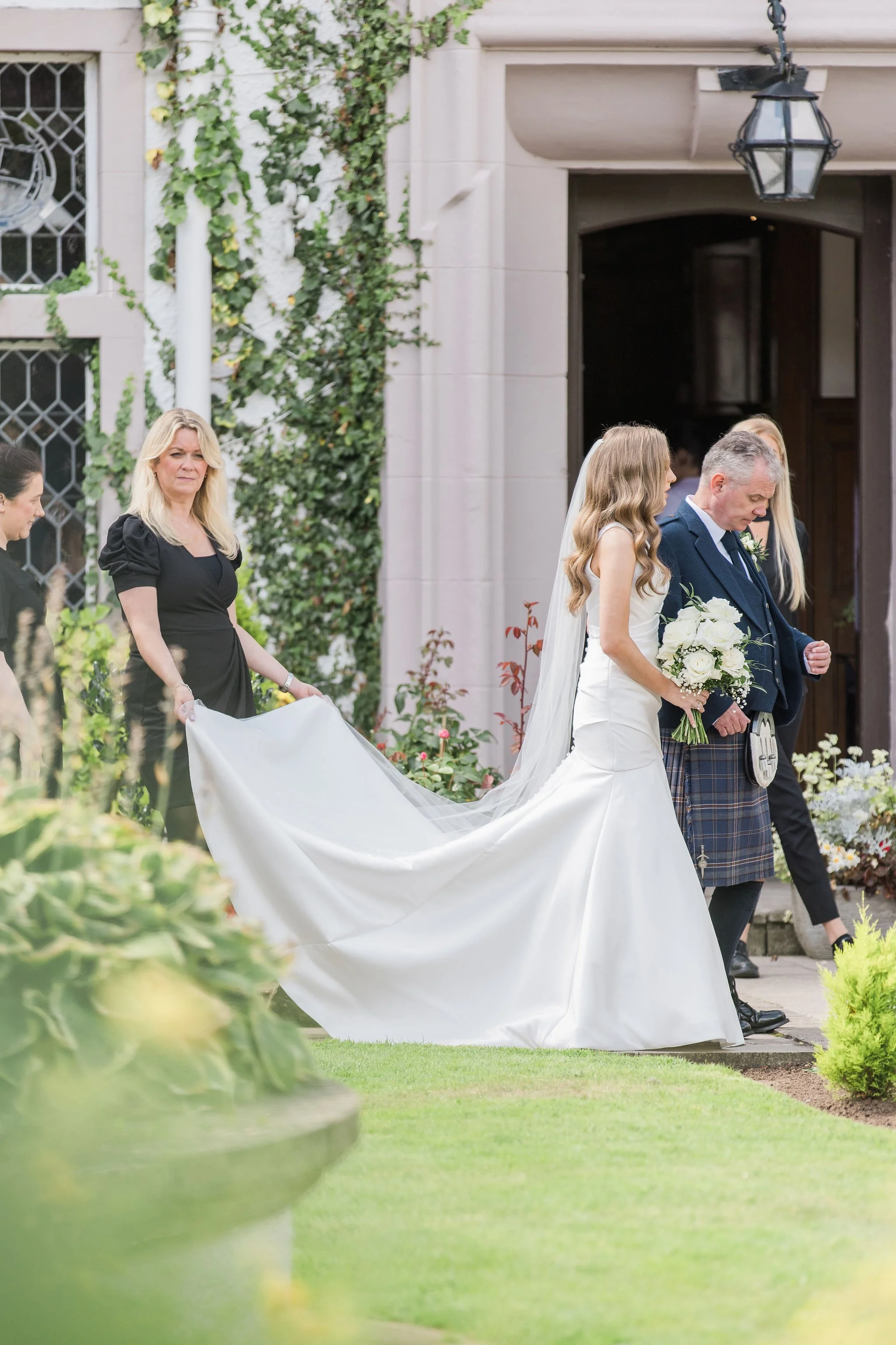 Bride walking outside of her Scotland wedding venue