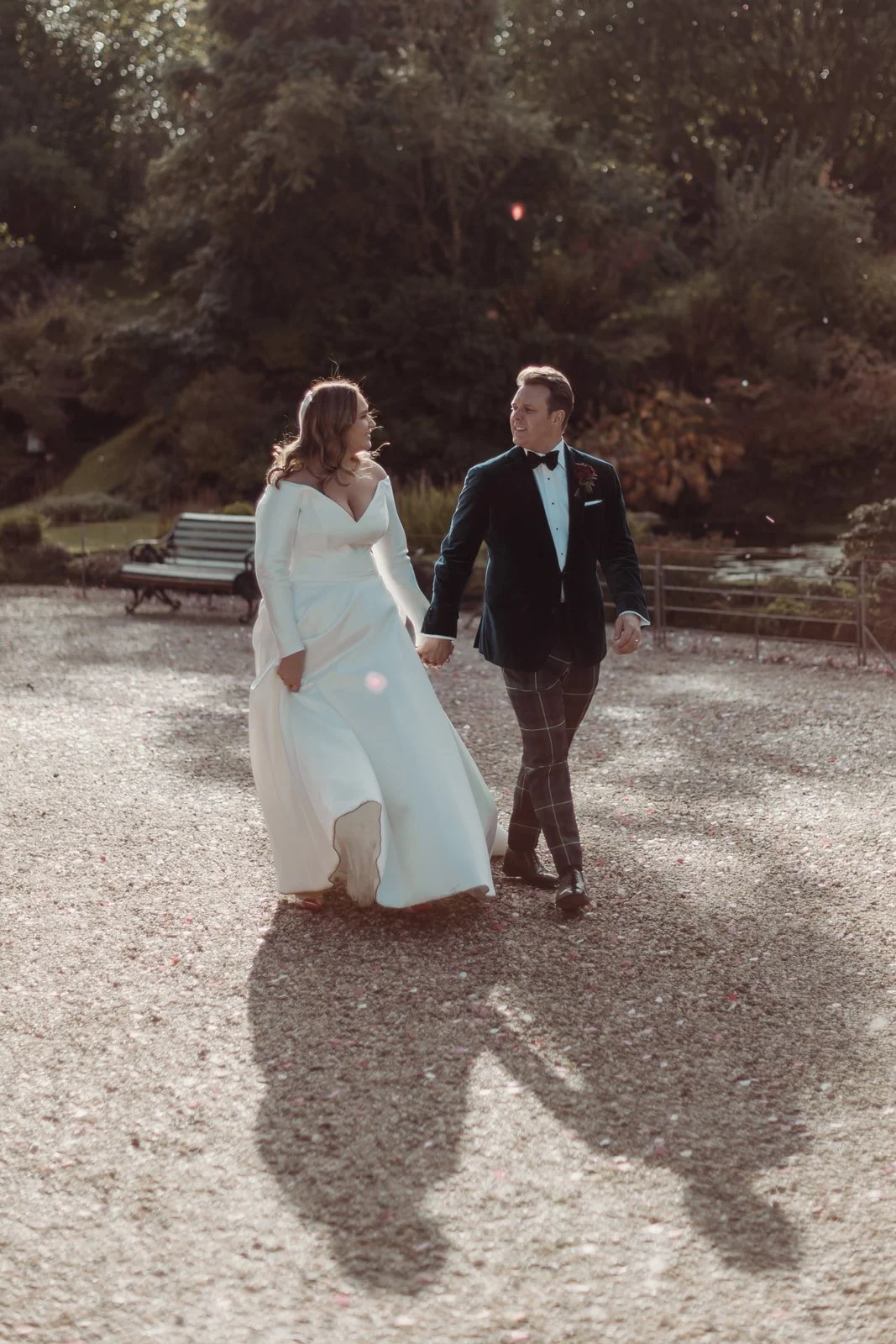 Bride and groom walking hand in hand during their winter wedding in Scotland
