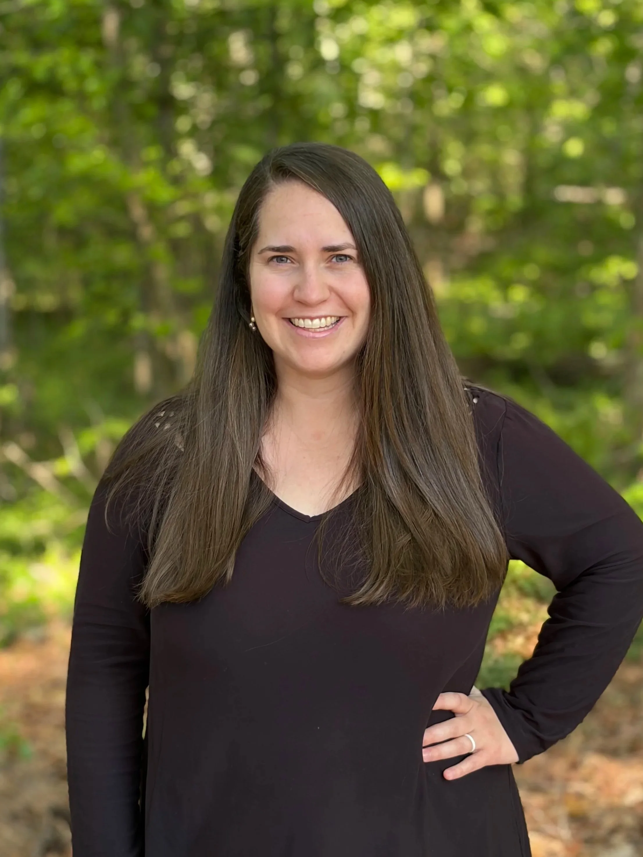 A smiling woman in black shirt