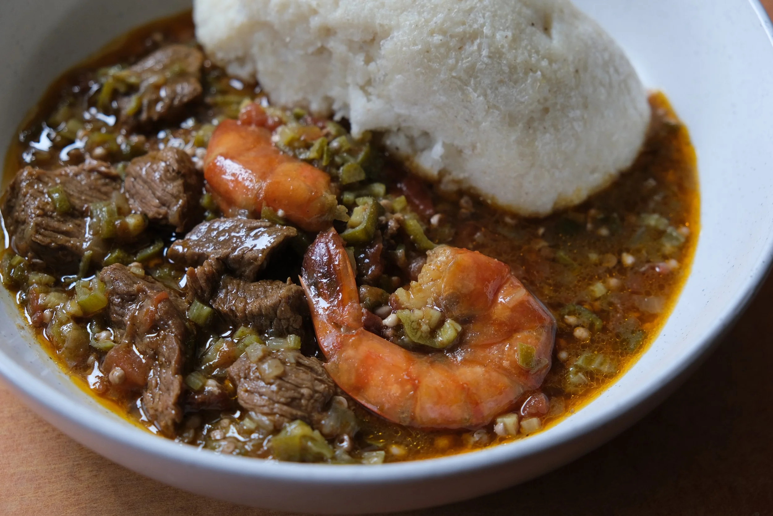 Beef stew with shrimp and okra served with ugali