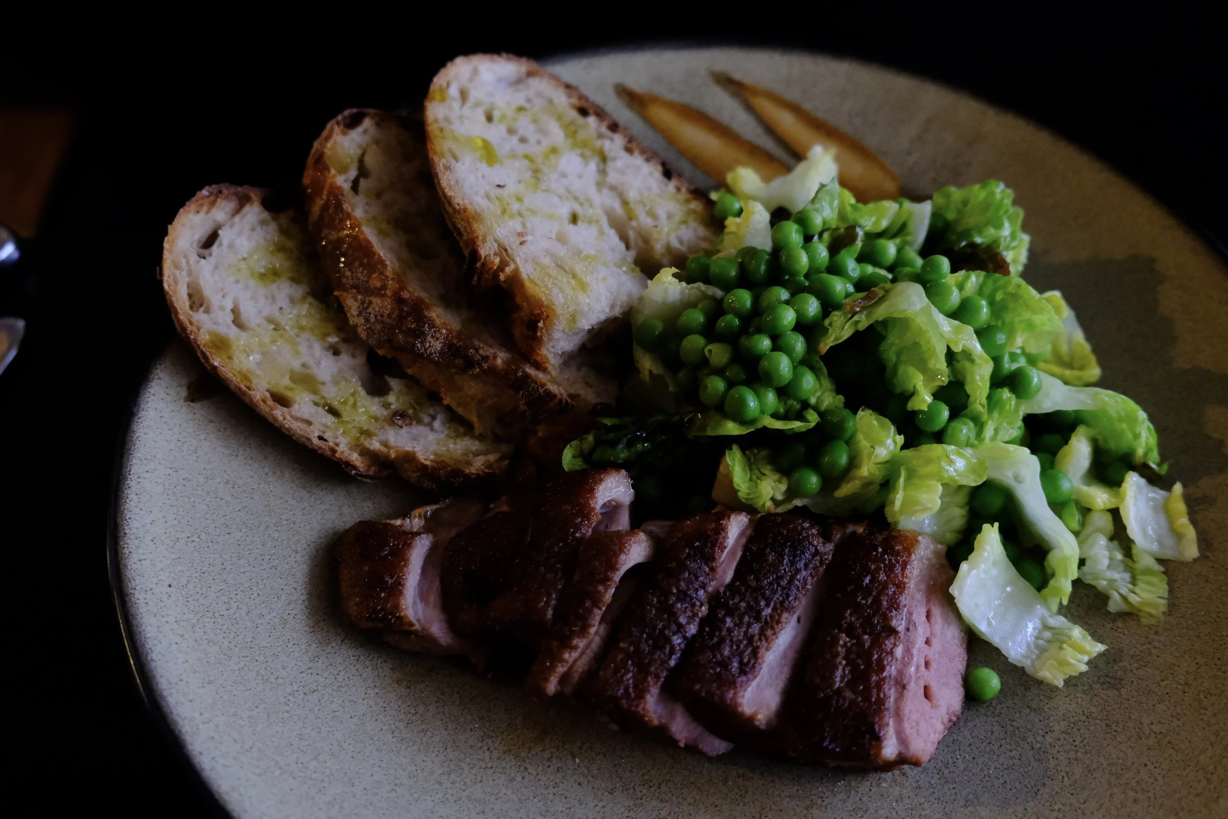 Seared duck with little gem lettuce and pea salad