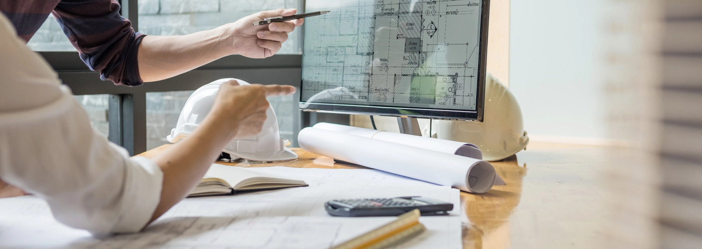 Engineer reviewing fire protection plan blueprints for AHJ submission