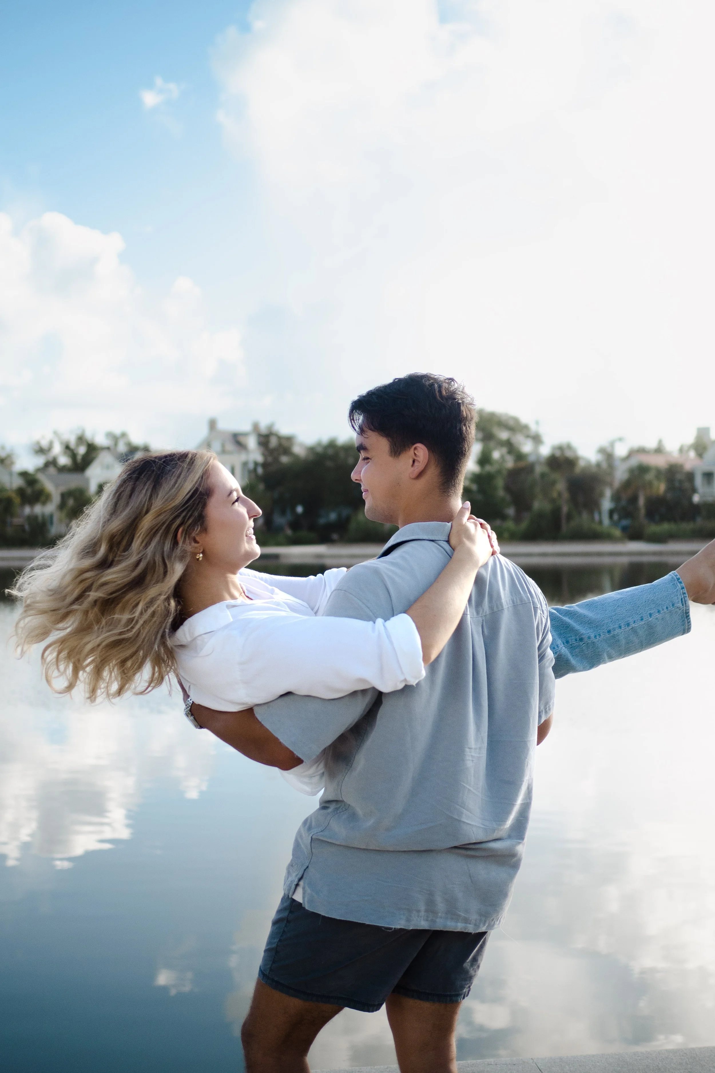 couple spinning around at park lake photoshoot