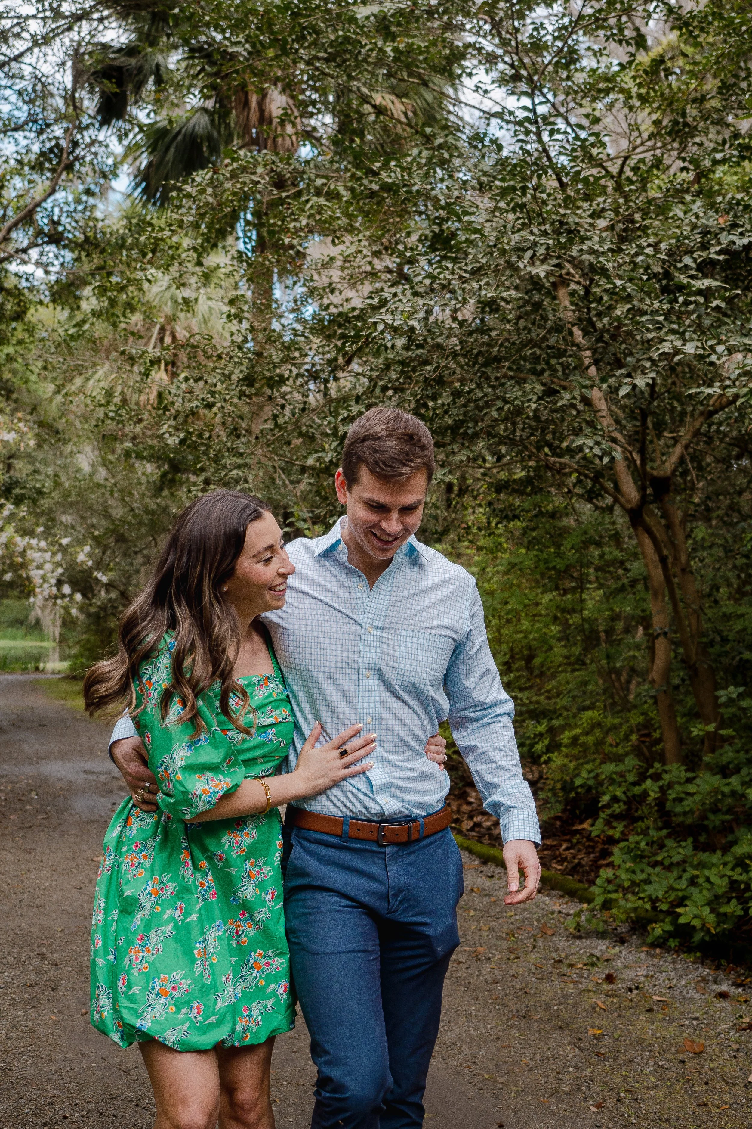 couple waling into each other in park engagement photoshoot