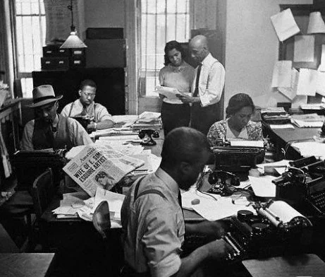 Reporters for the New York Amsterdam News at work in the newsroom, 1936