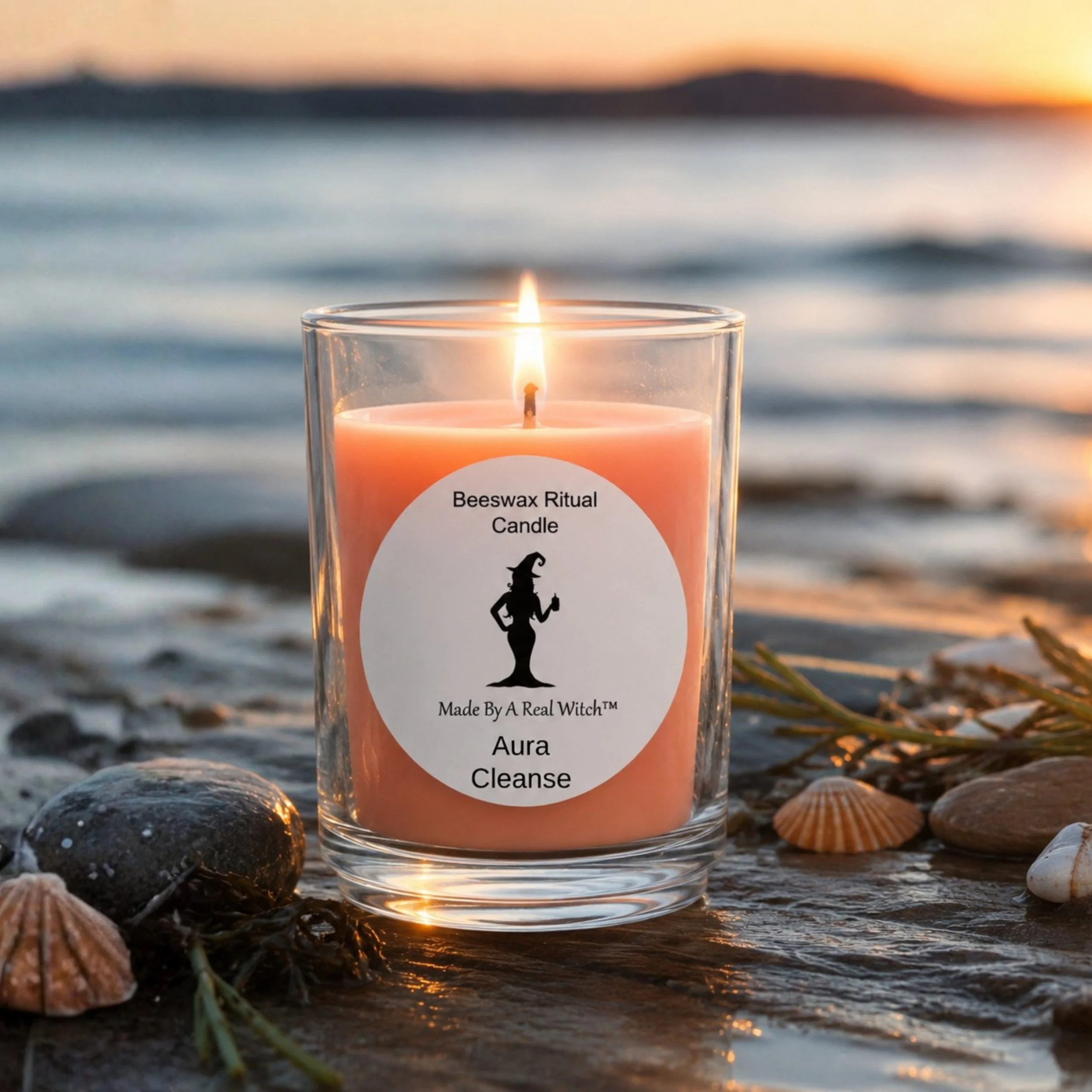 Aura Cleanse beeswax ritual candle by Made By A Real Witch™ burning beside calm water in Nova Scotia.