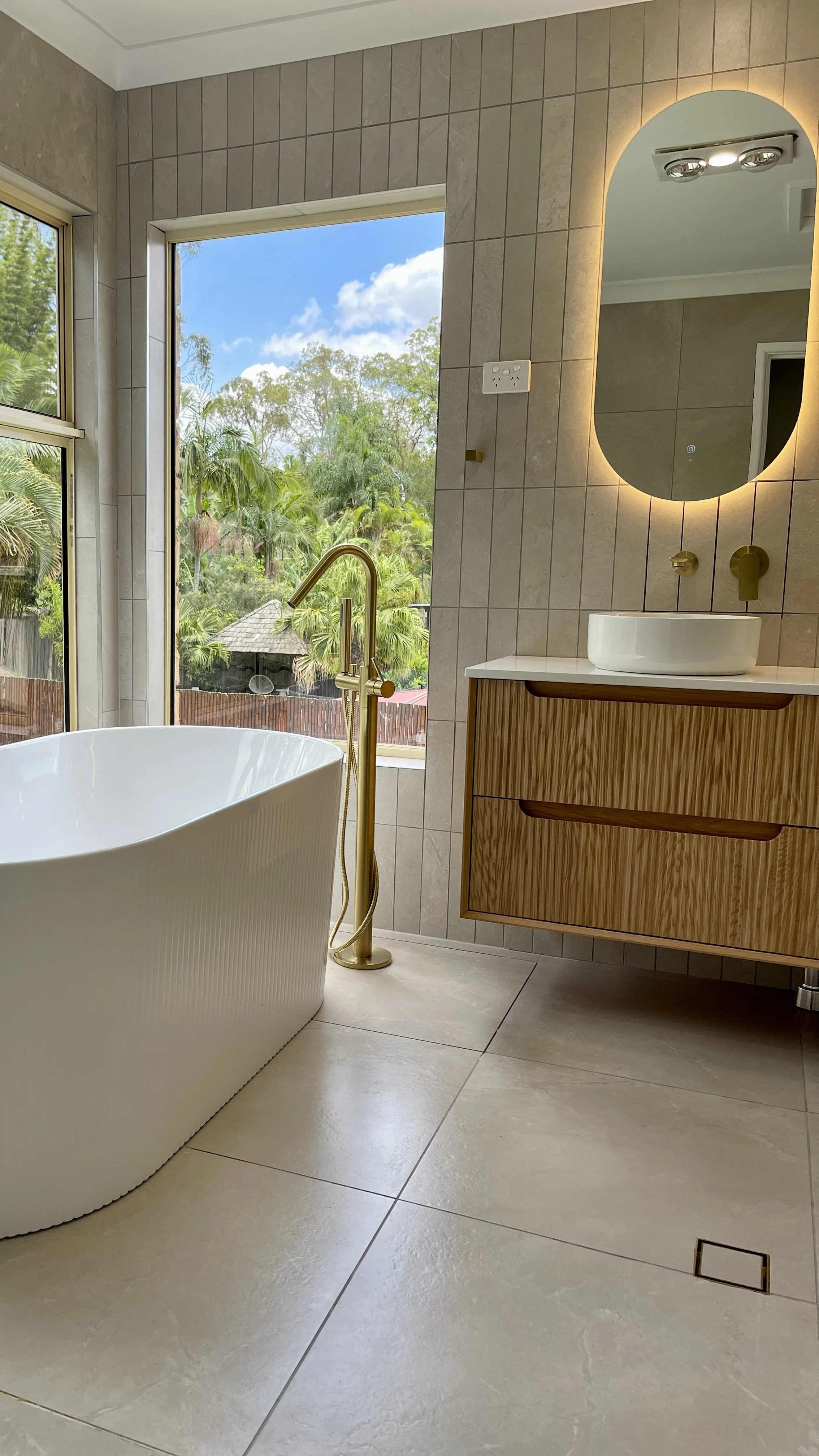Shailer Park, Logan area, Southside of Brisbane bathroom renovation. Beautiful modern bathroom, white basin, timber ribbed vanity, white ribbed bath tub. 