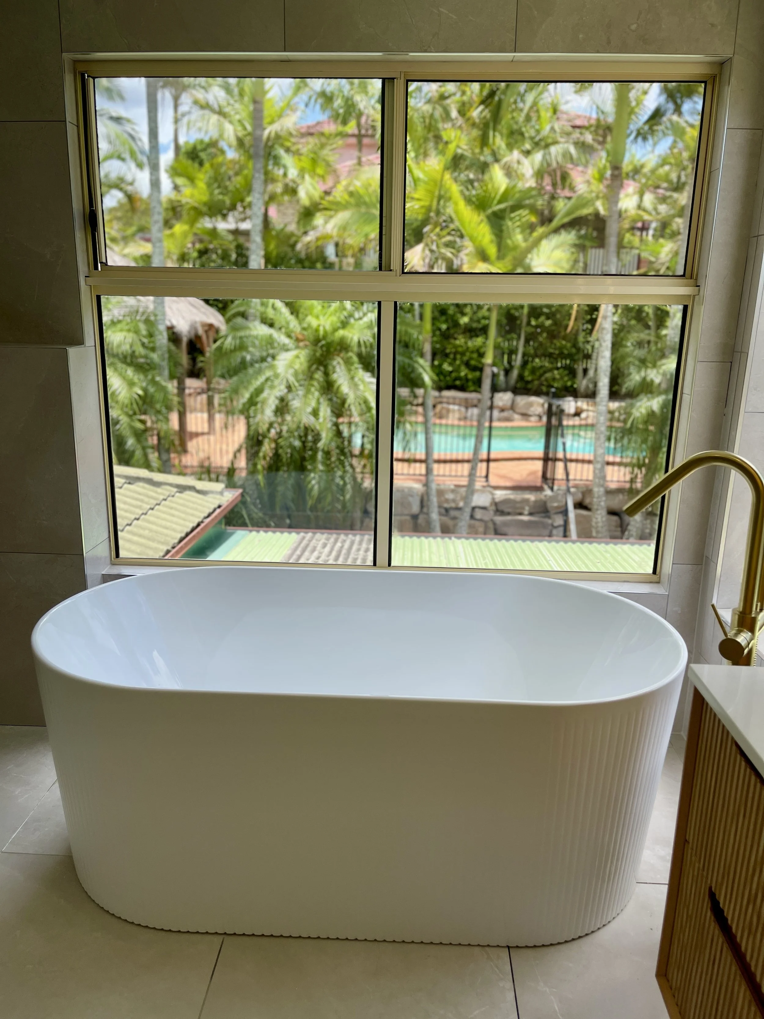 Shailer Park, Logan area, Southside of Brisbane bathroom renovation. Beautiful modern bathroom, white basin, timber ribbed vanity, white ribbed bath tub. 