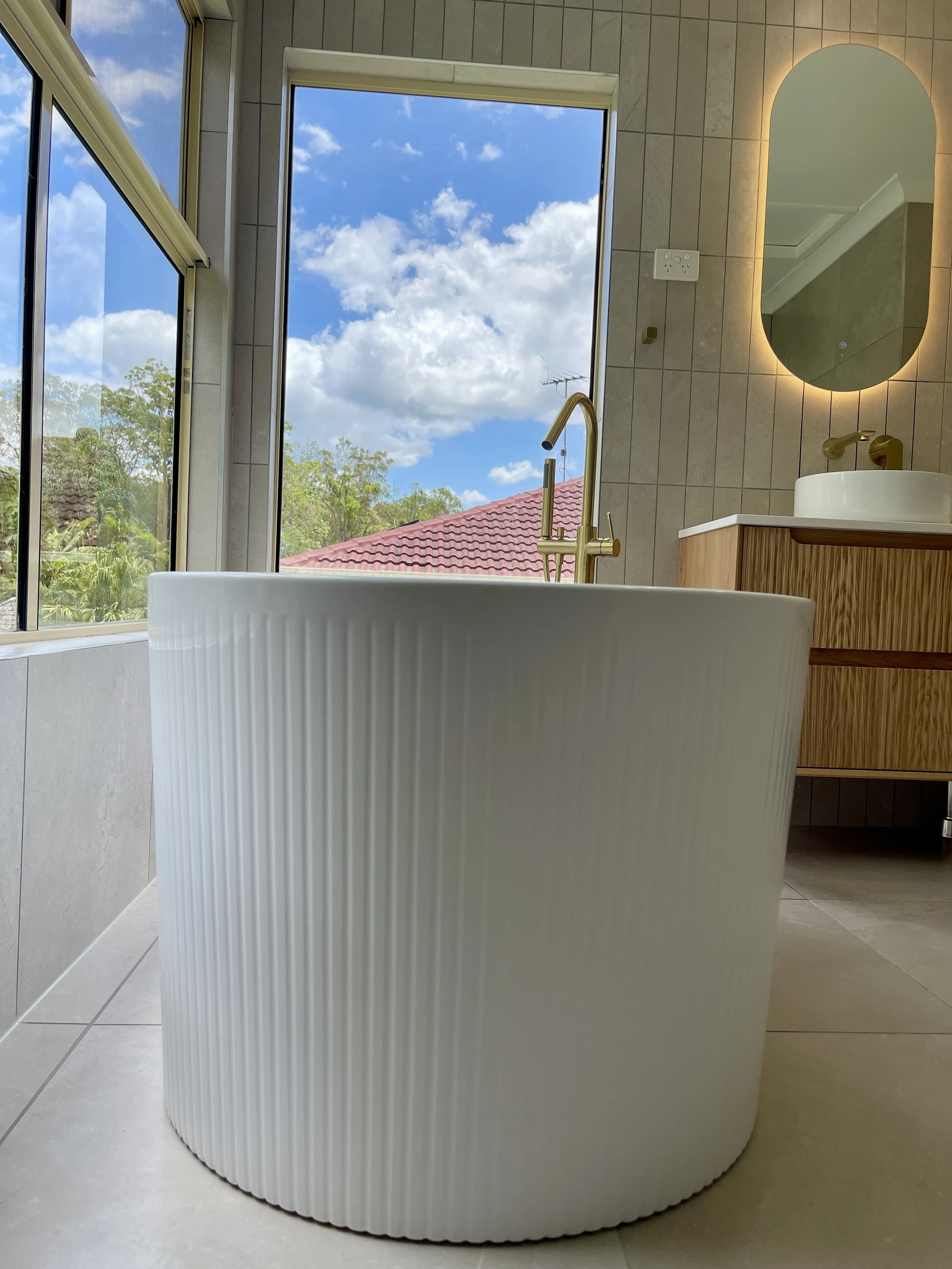 Shailer Park, Logan area, Southside of Brisbane bathroom renovation. Beautiful modern bathroom, white basin, timber ribbed vanity, white ribbed bath tub. 