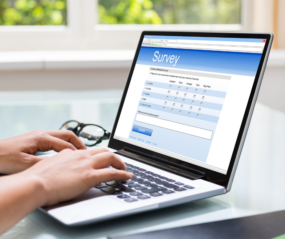 Person using laptop with online survey form on screen