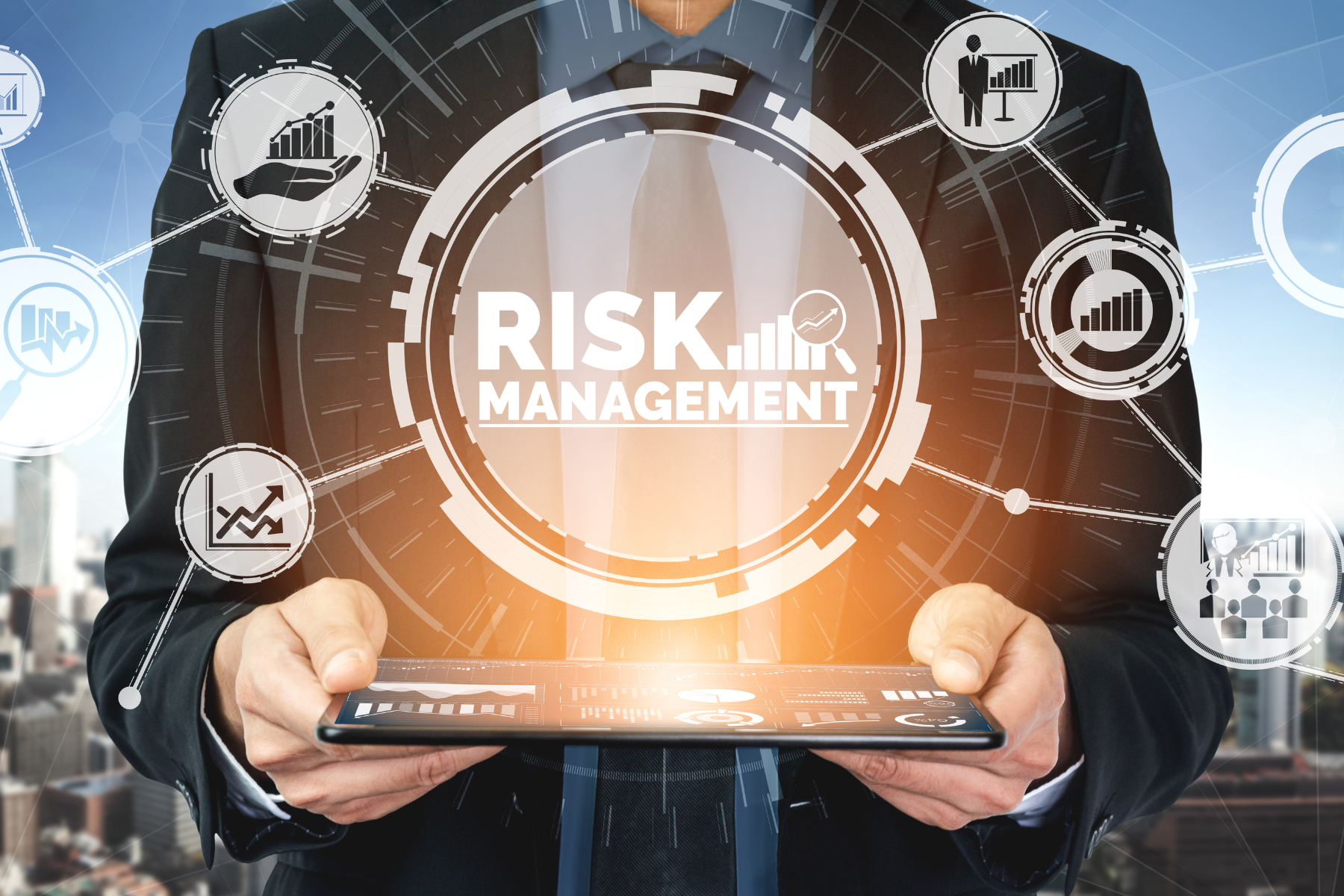 Businessman holding tablet with "Risk Management" graphic overlay.