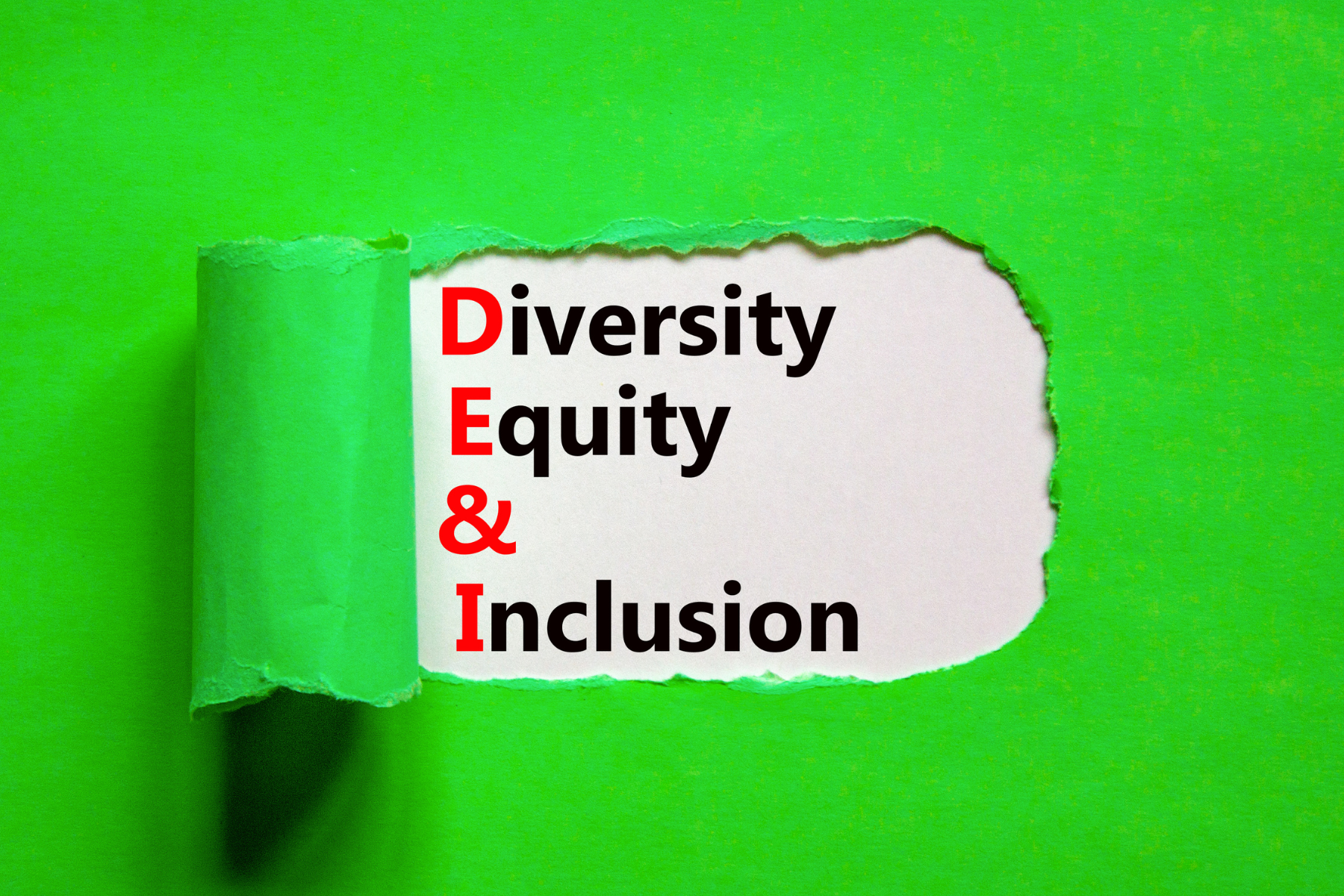 "Diversity, Equity & Inclusion" text on torn green paper background.