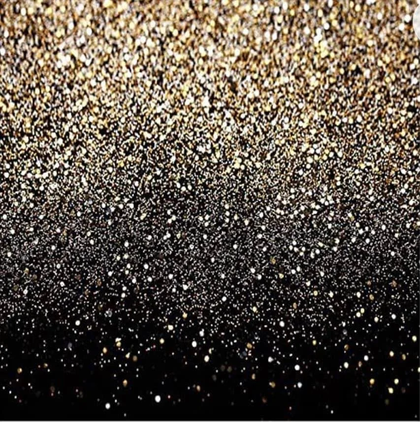 Close-up of gold and black glittery surface.