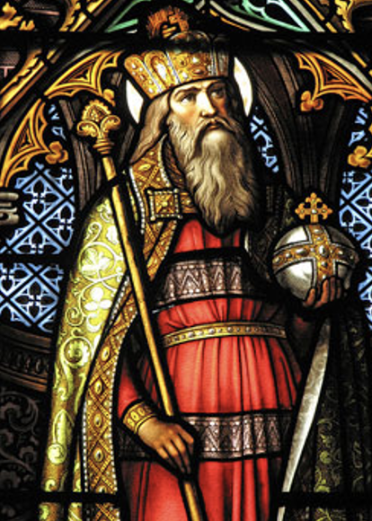Stained glass depiction of a king with a crown, scepter, and orb.