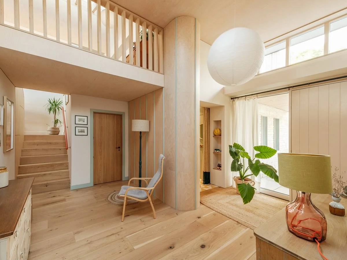 Entrance hallway at Sky House - designed for busy family life. 

We set out to keep as much of the existing structure as possible, reducing our embodied carbon footprint wherever possible. But the existing house was a warren of rooms and the entrance