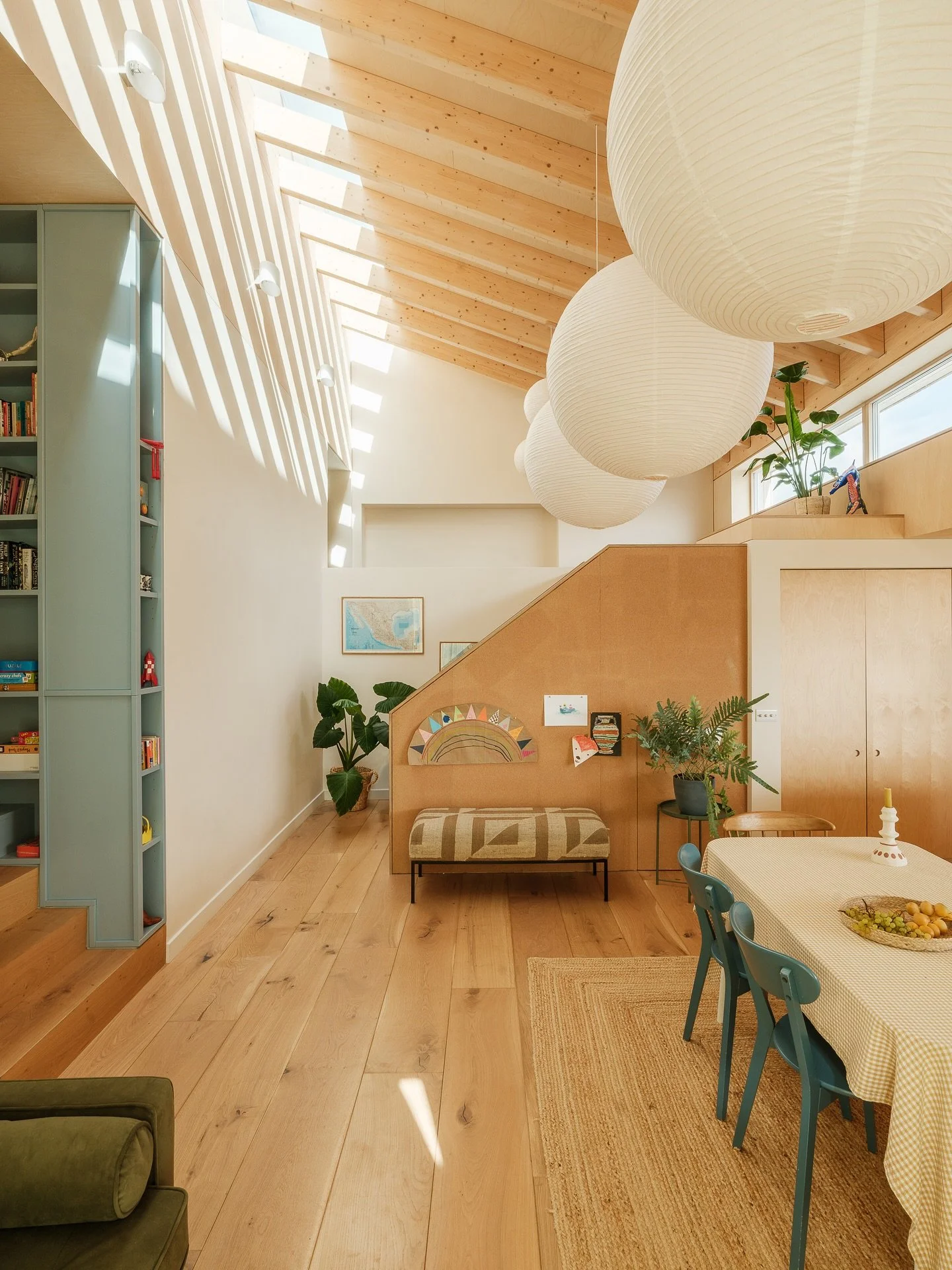 Main living space at Sky House - designed to be open, generous and full of light

Our main gesture was to remove part of the existing roof and replace with an exposed timber ceiling flooded at the ridge by a 9m long skylight. This space is the heart 