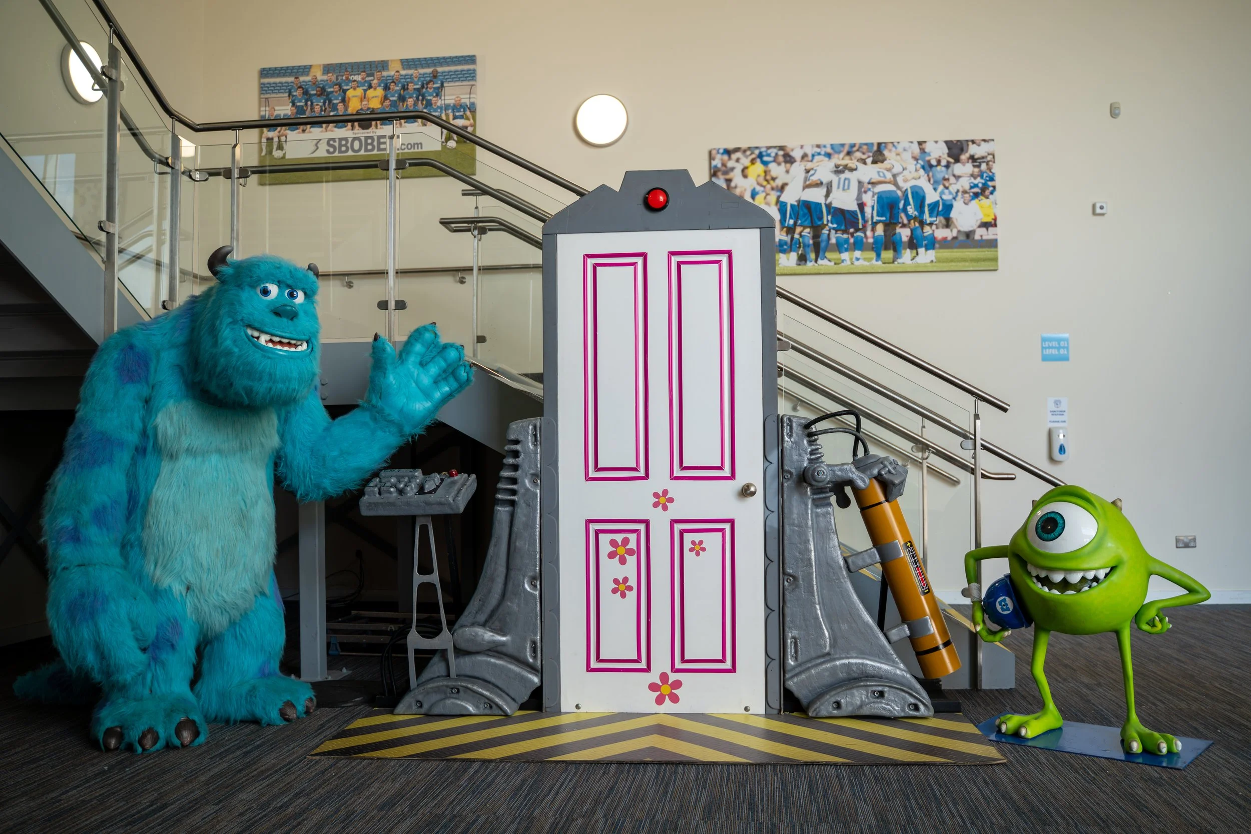 Monsters, Inc. display featuring Sulley, Mike Wazowski and Boo’s door