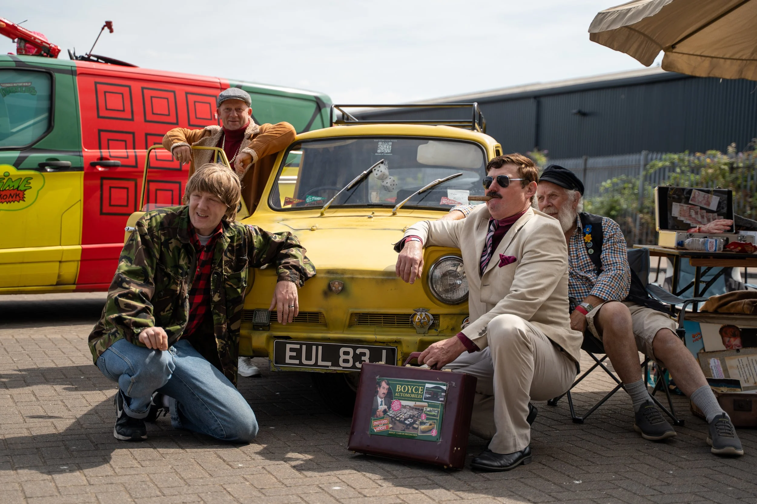 The Welsh Trotters Del Boy and Rodney cosplayers beside the Trotters Independent Traders van